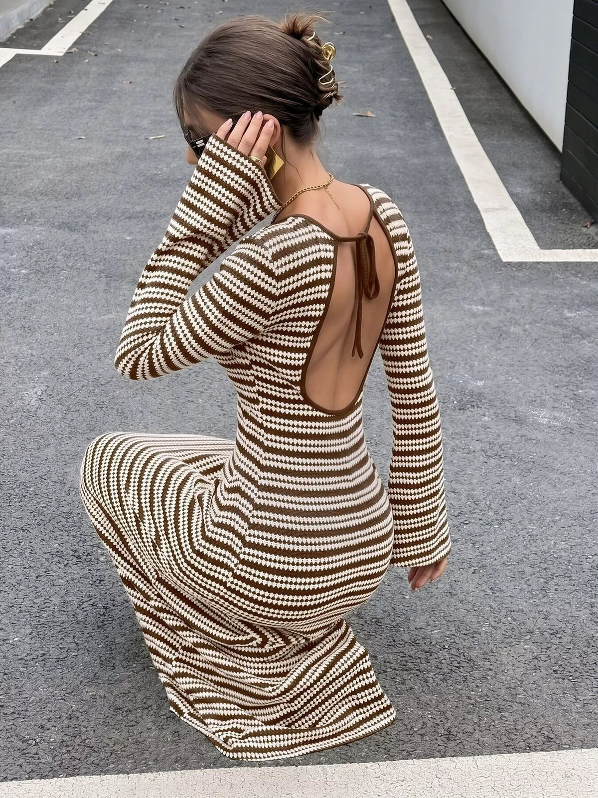 Brown and white striped flare sleeve knit dress, seated open-back view