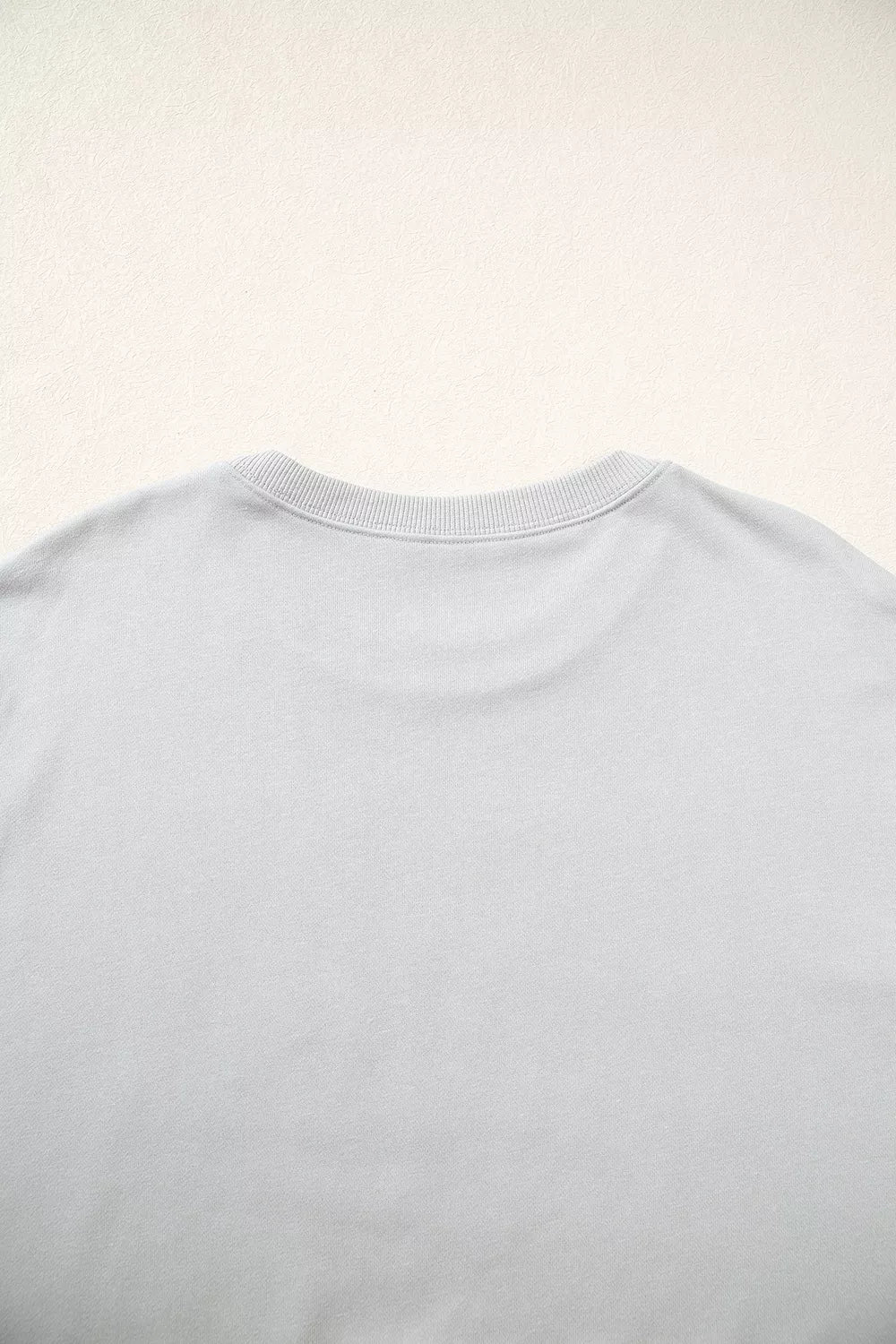 Gray floral and plaid PRAY patch sweatshirt, back neckline