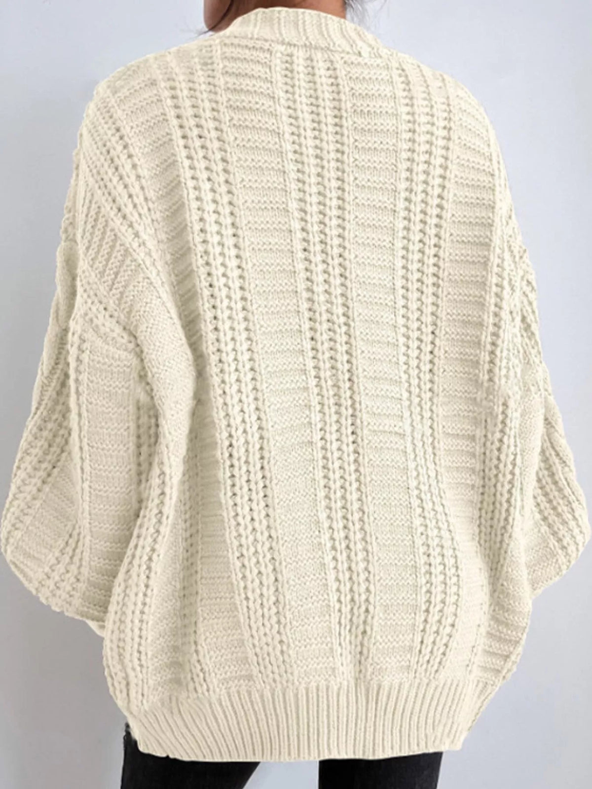Cream cable knit button-down cardigan, back view