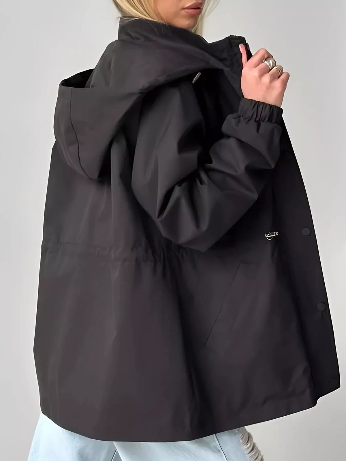 Black hooded drawstring waist windbreaker jacket, back view