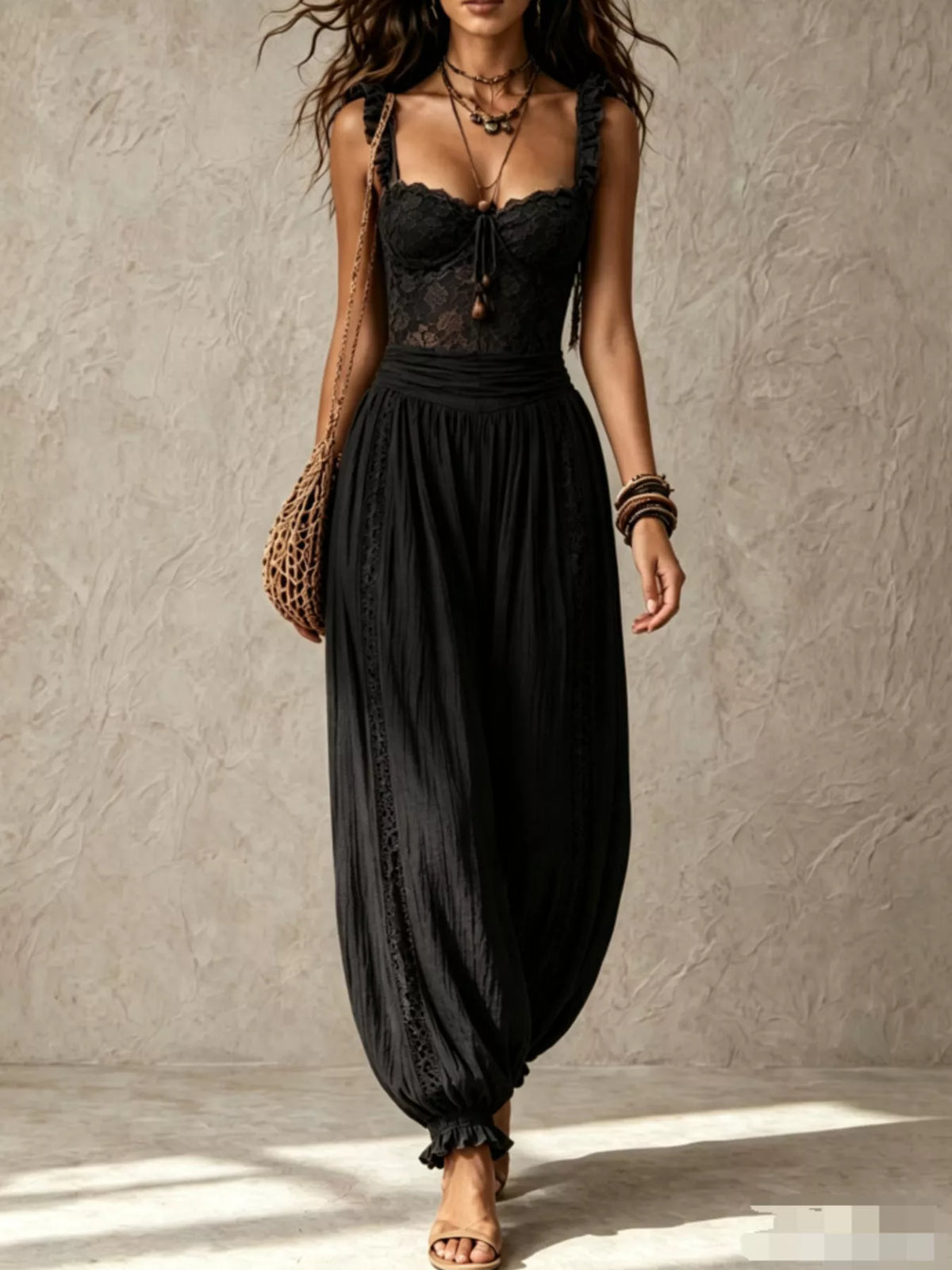 Black lace-bodice harem-leg jumpsuit, full front view.