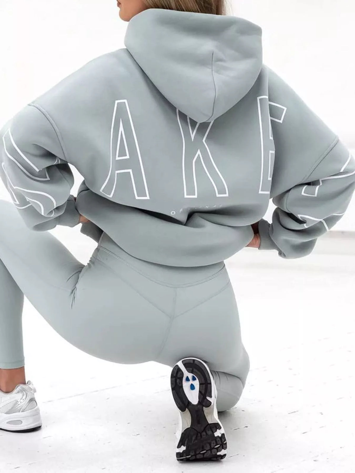 Light blue letter-print pullover hoodie with kangaroo pocket, back lettering view