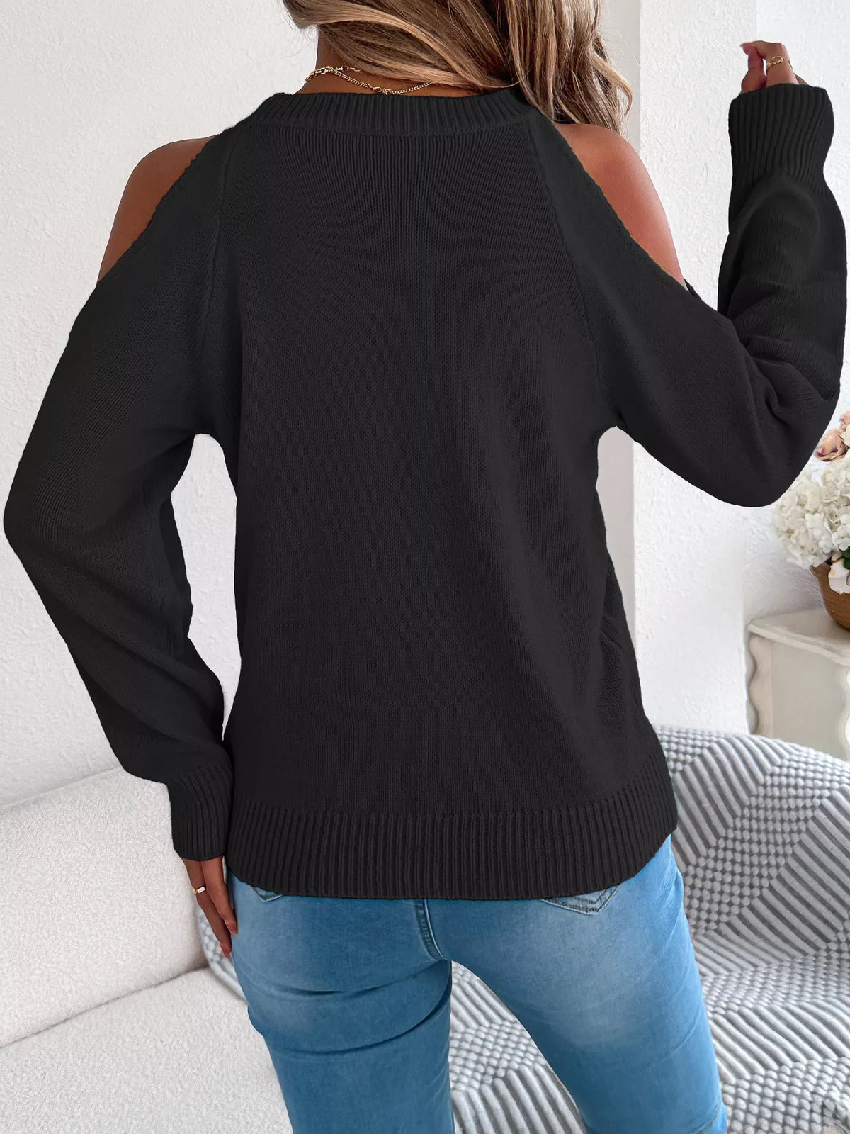 Black cold shoulder cable knit sweater, back view