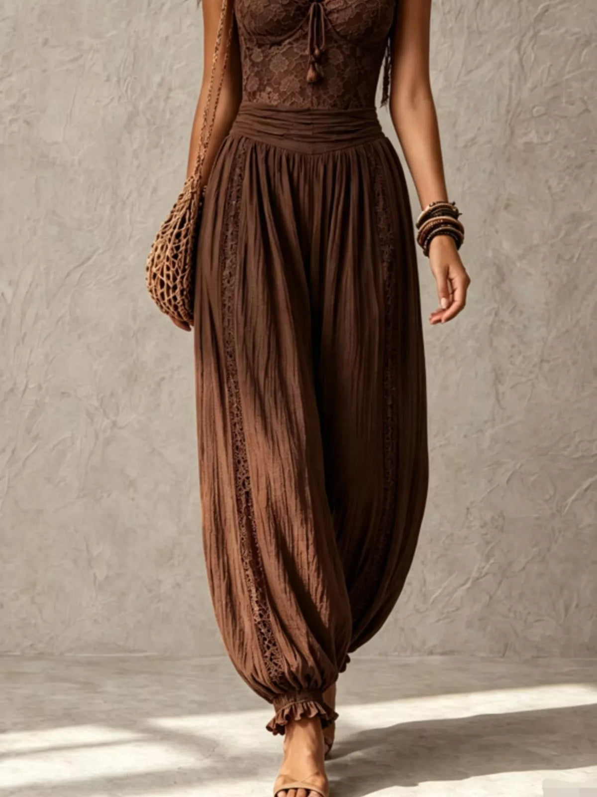 Brown lace-bodice harem-leg jumpsuit, harem pants detail.