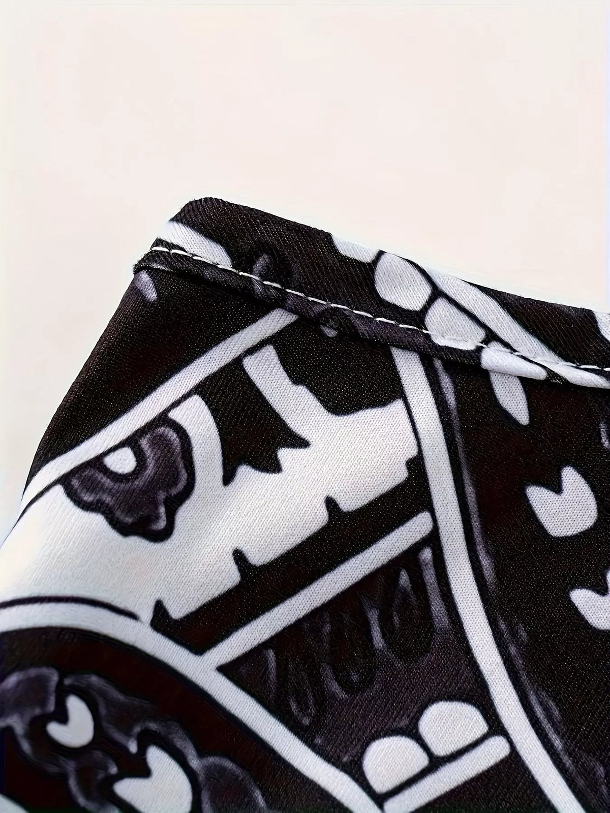 Black and white printed spaghetti strap maxi dress, close-up of the printed neckline edge