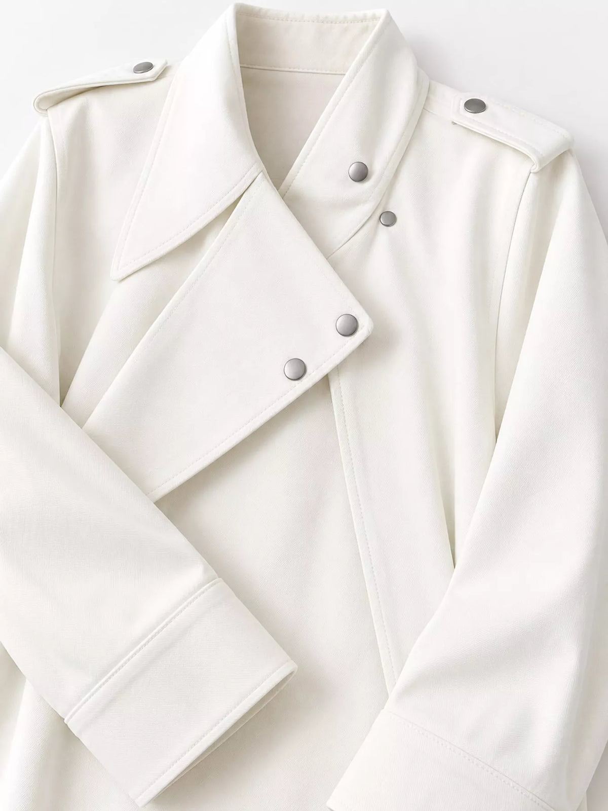Cream asymmetric zip-up moto-style jacket, snap lapels, shoulder tabs, and cuff