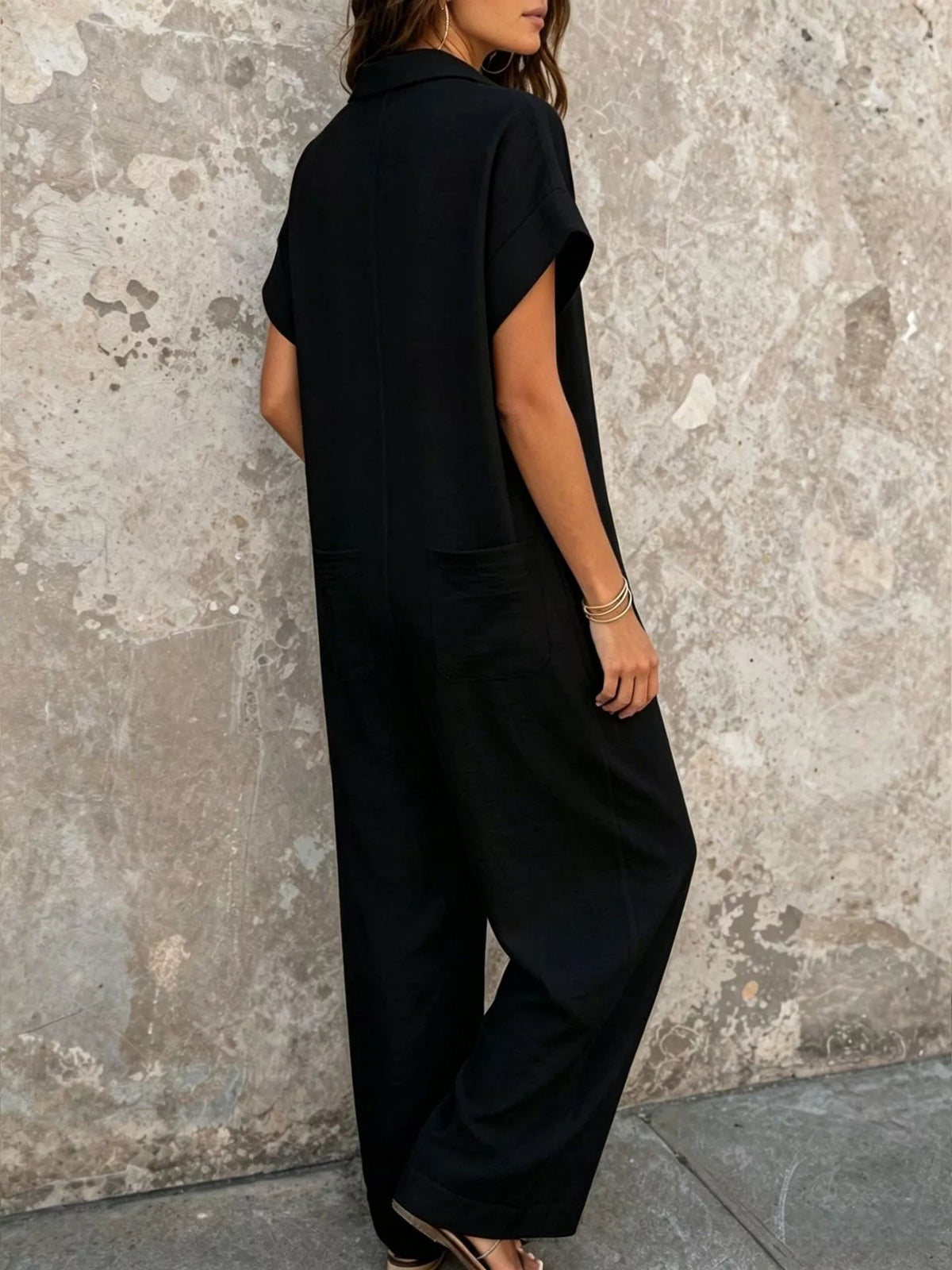 Black button-front jumpsuit, back view
