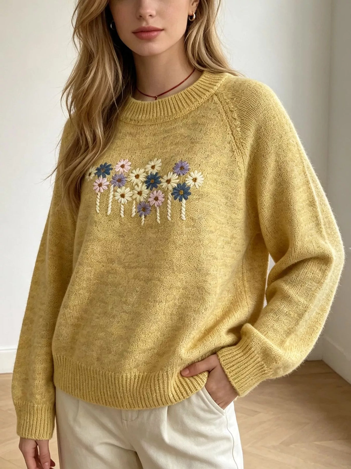 Floral embroidered round-neck sweater in yellow, angled front view