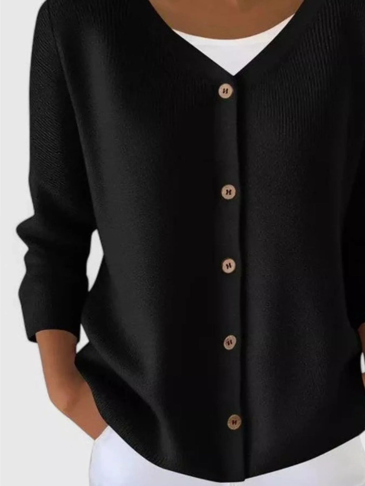 Black ribbed button-front cardigan, lower-front detail