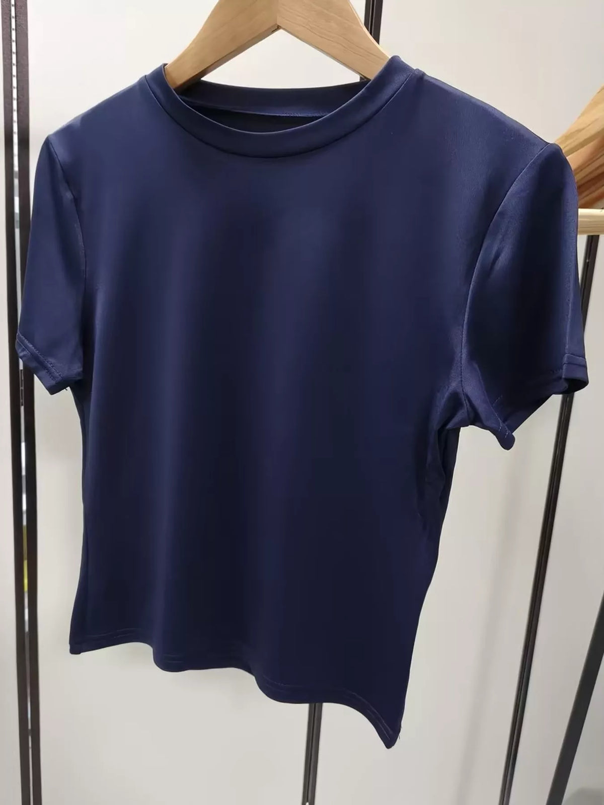 Navy crew neck crop T-shirt, front on hanger