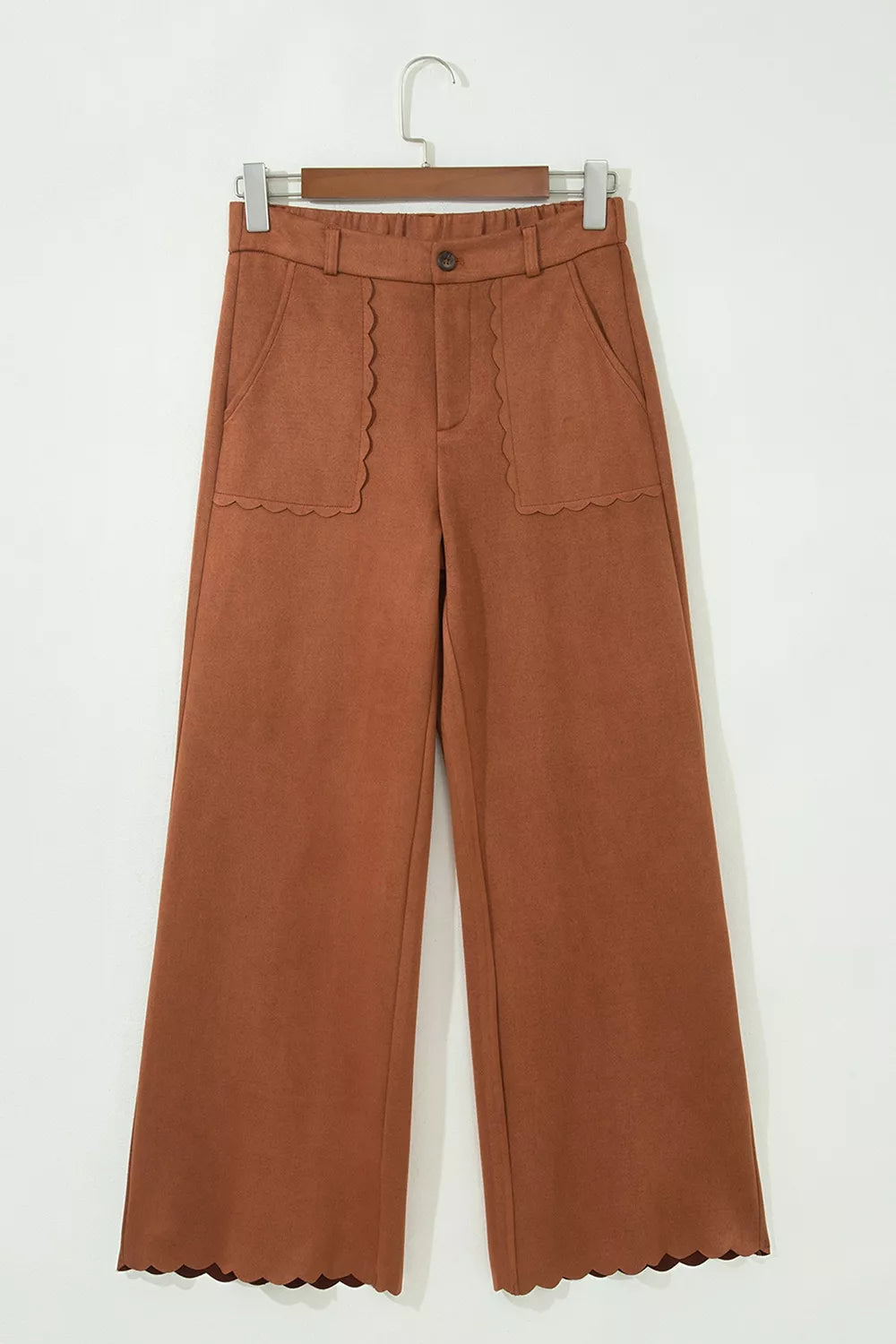 Brown scalloped-pocket wide-leg pants, front on hanger