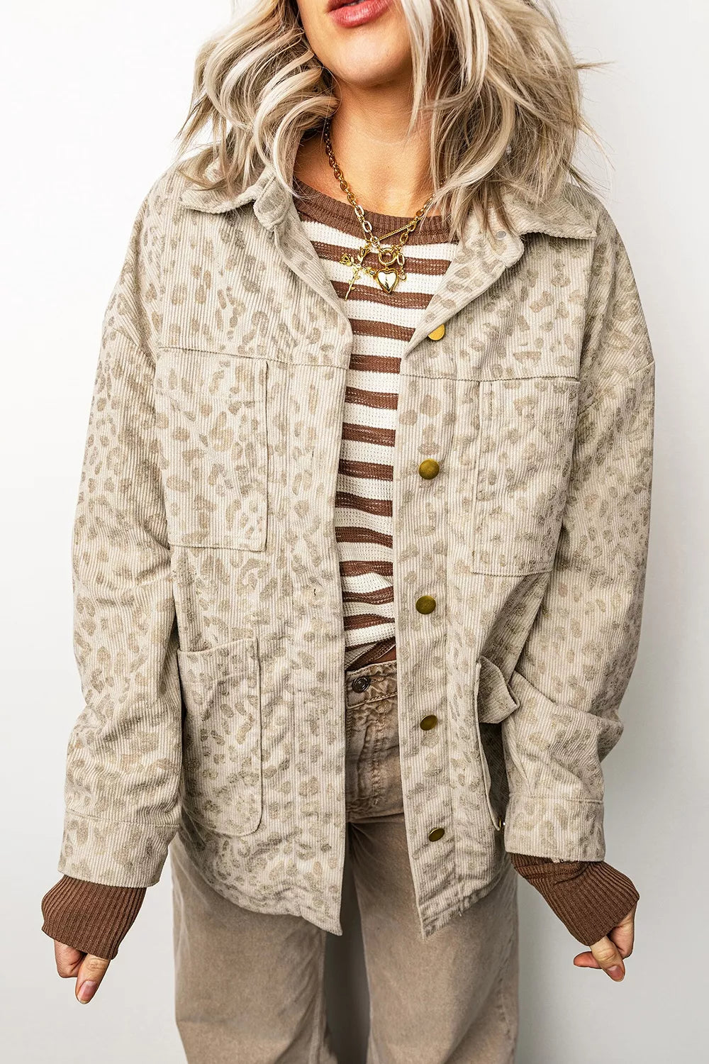 Beige leopard corduroy button-front jacket, front view showing curved hem.