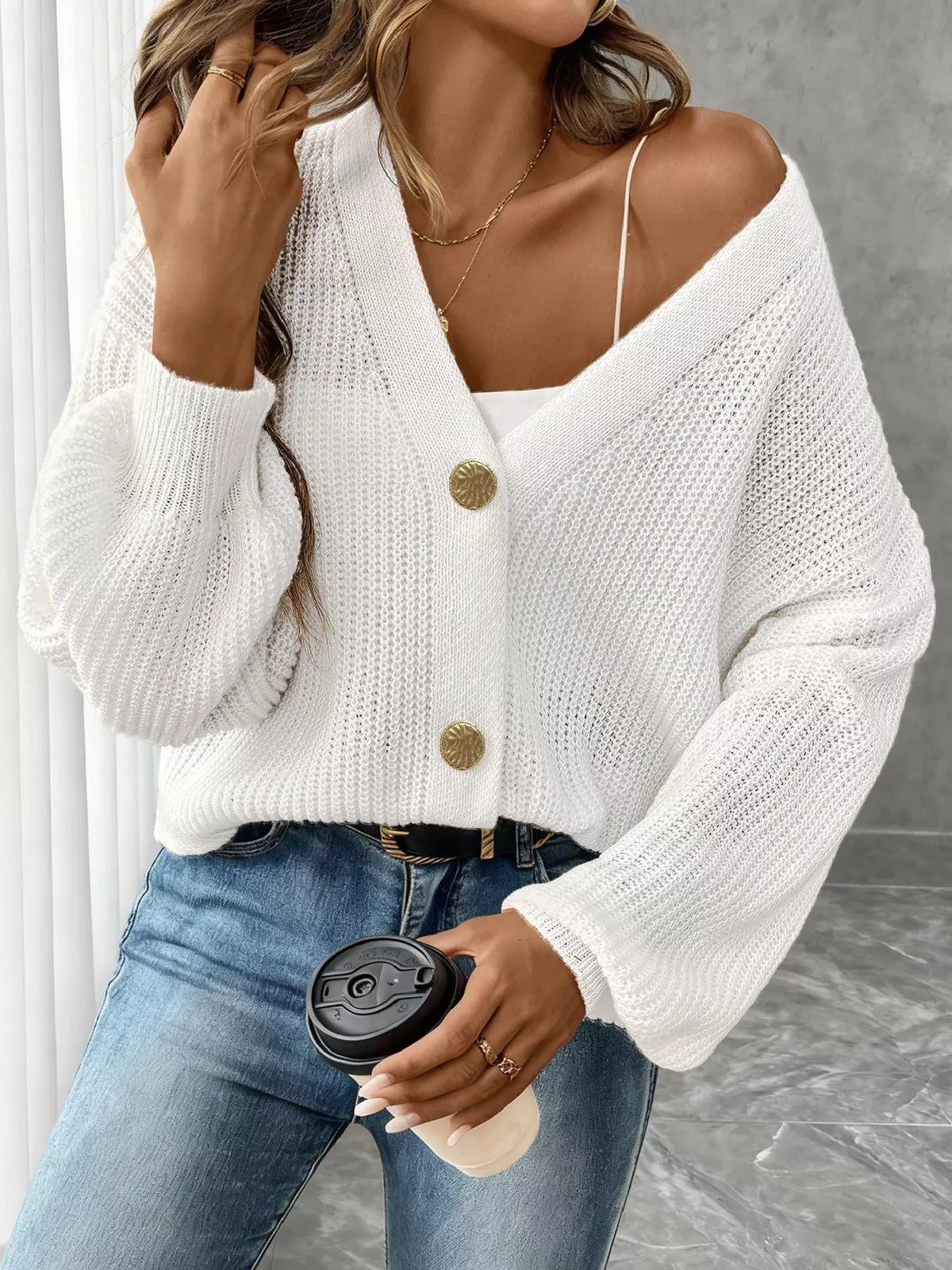 V-neck ribbed knit cardigan in white, front view worn off one shoulder