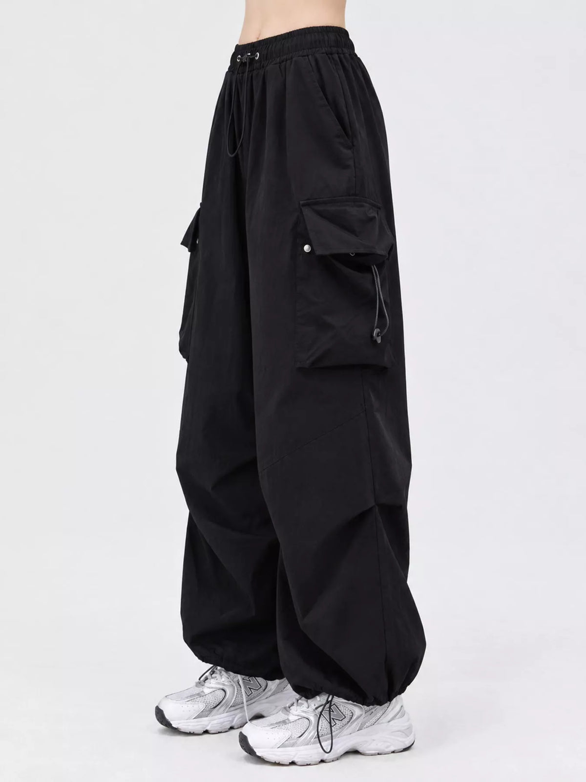 Black drawstring cargo pants, side view