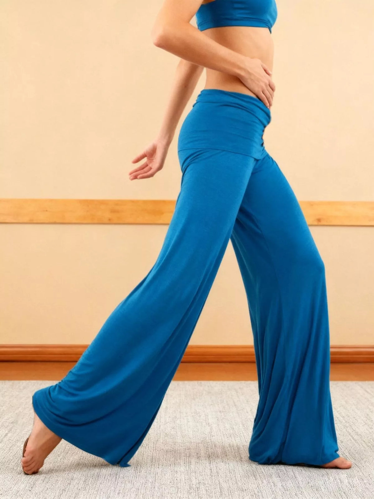 Blue fold-over wide-leg pants, side view, walking pose