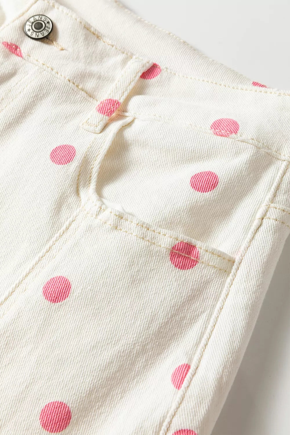 White with pink dots polka-dot cropped jeans, front pocket and button close-up