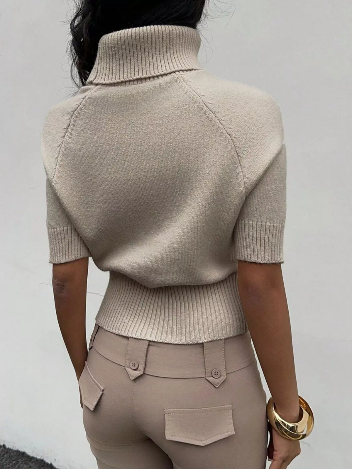 Beige turtleneck short-sleeve cropped sweater, back view.