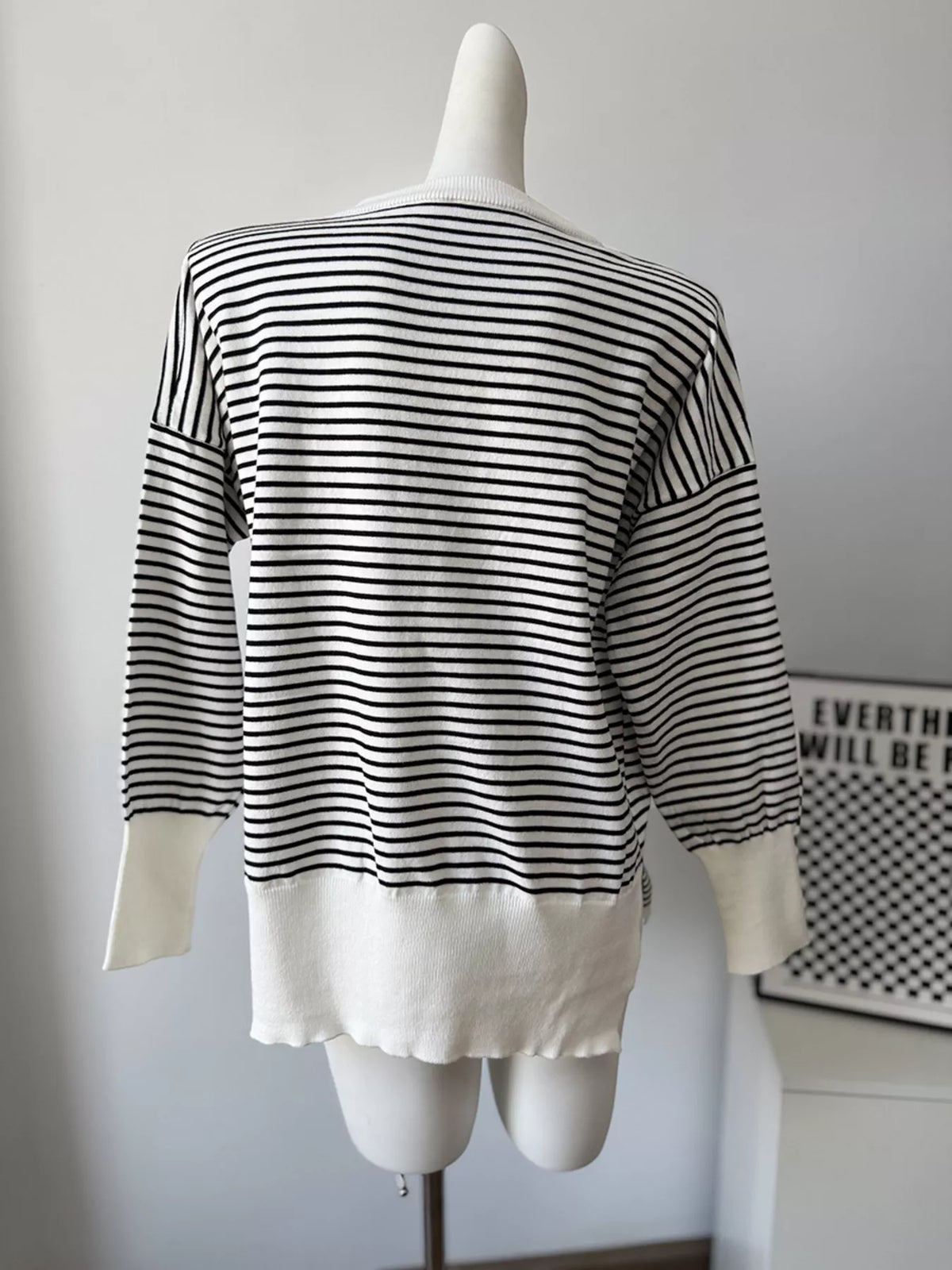 Striped round-neck knit top in white and black, back mannequin view