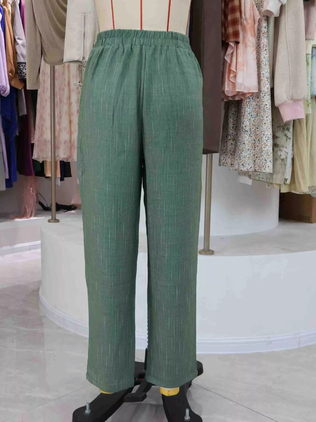 Green loose fit cropped pants, back view