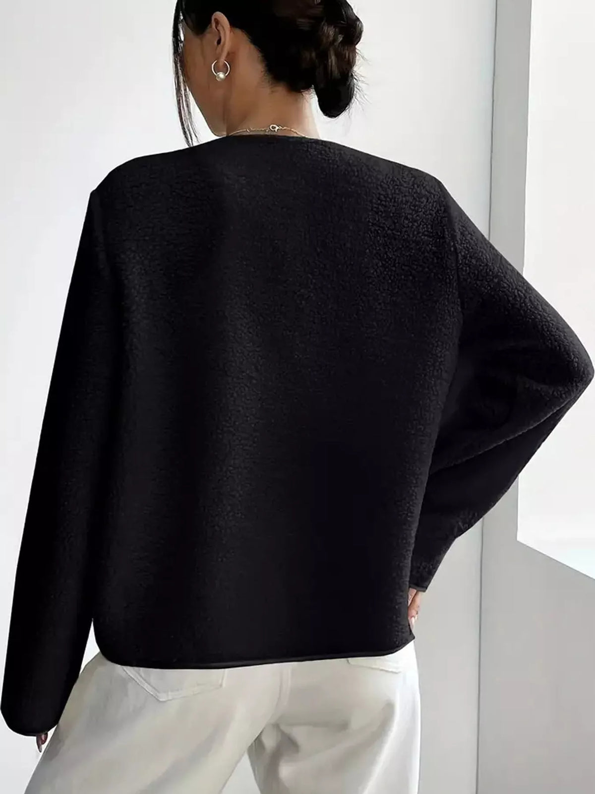 Black textured button-front jacket — back view