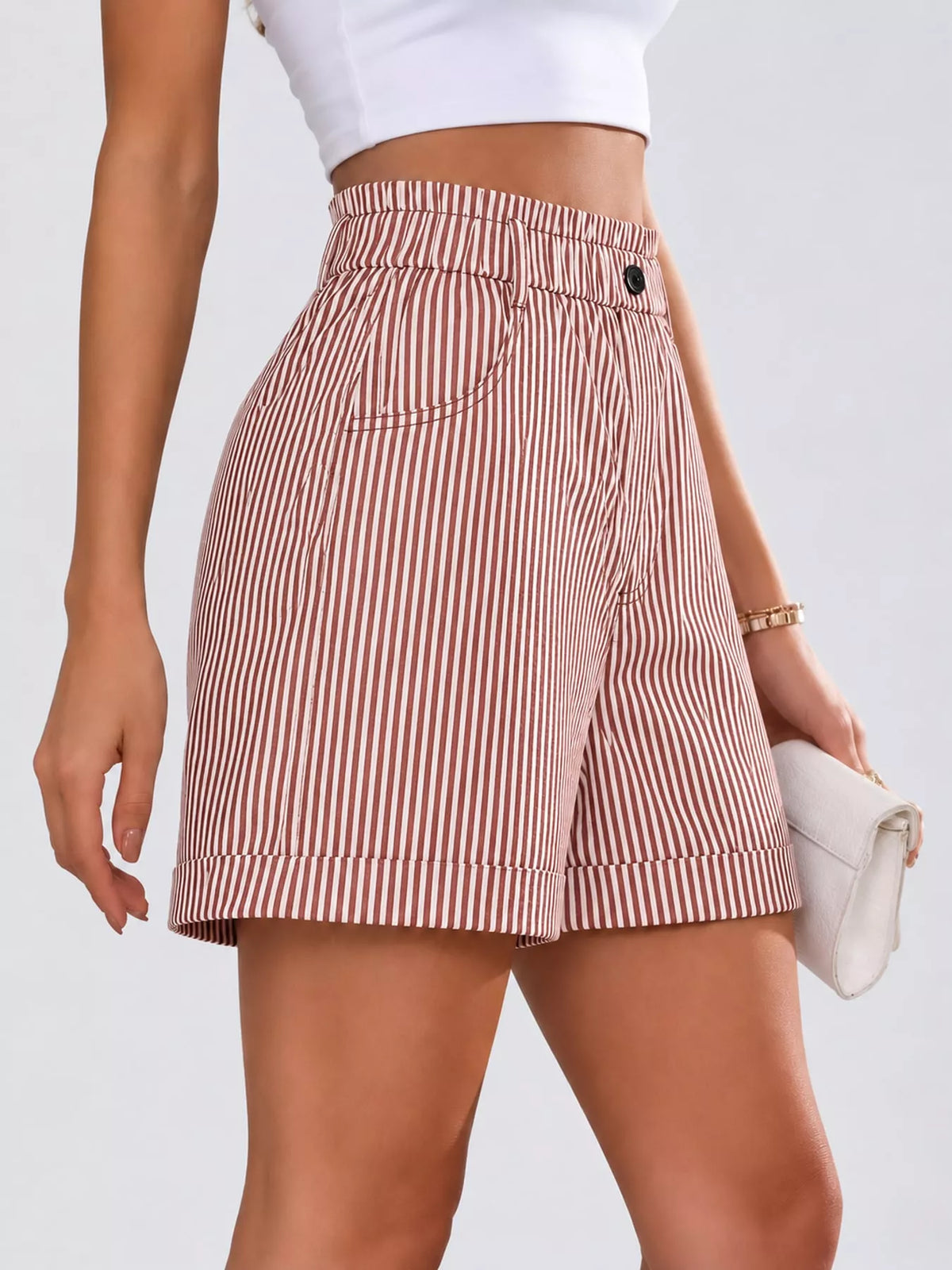 Pink and white high waisted striped shorts, side view