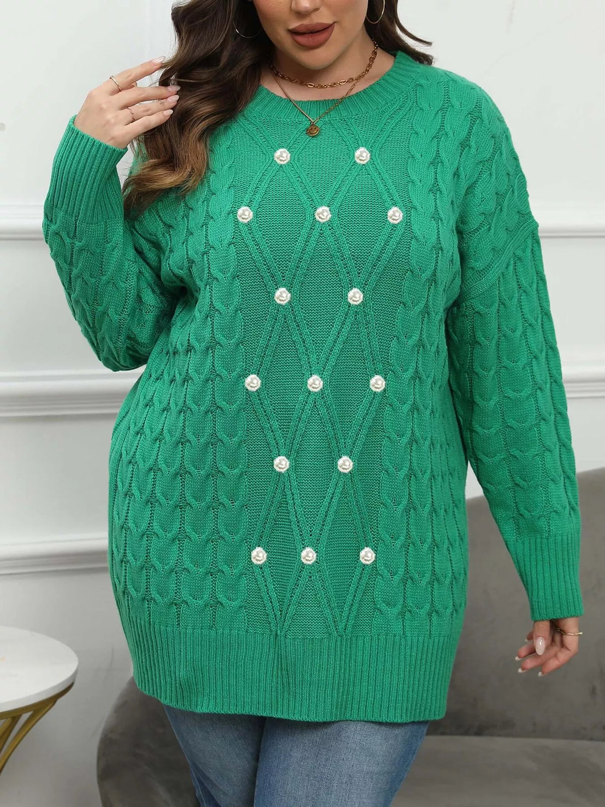 Green plus-size cable-knit sweater with pearl-like front accents, full front view