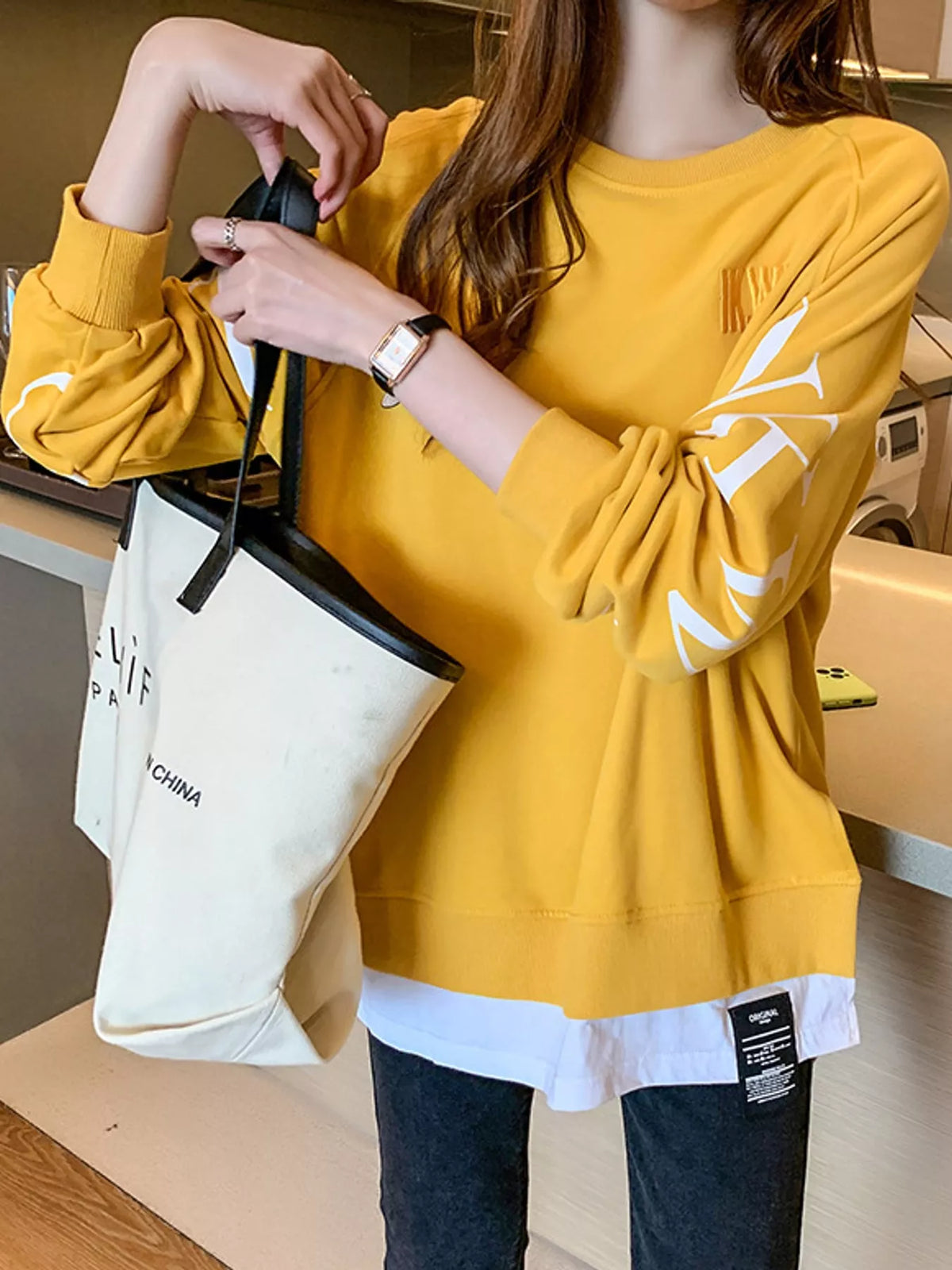 Yellow layered-hem sweatshirt with graphic sleeve detail