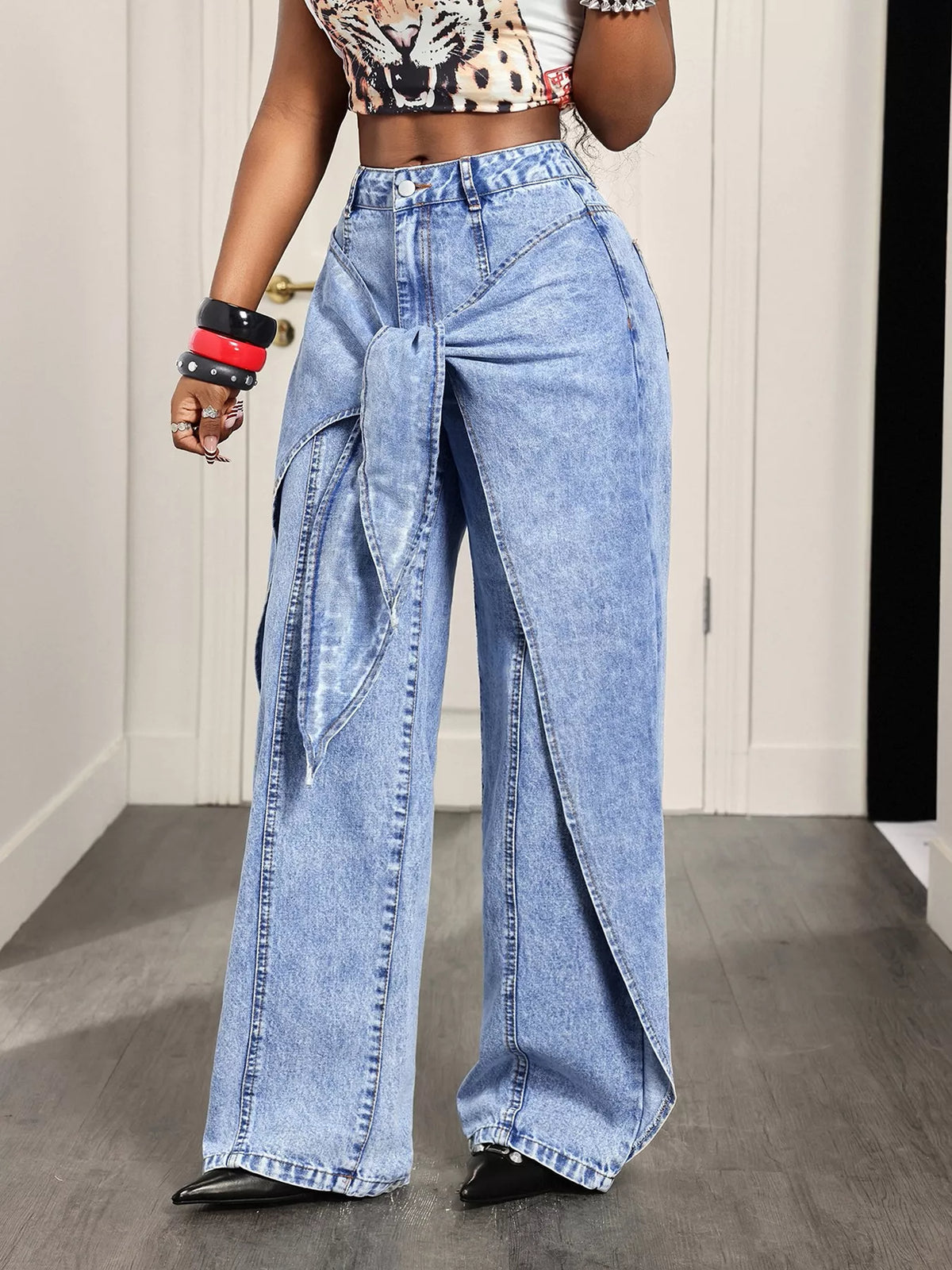 Light blue ruffled wide-leg jeans, front view at an angle