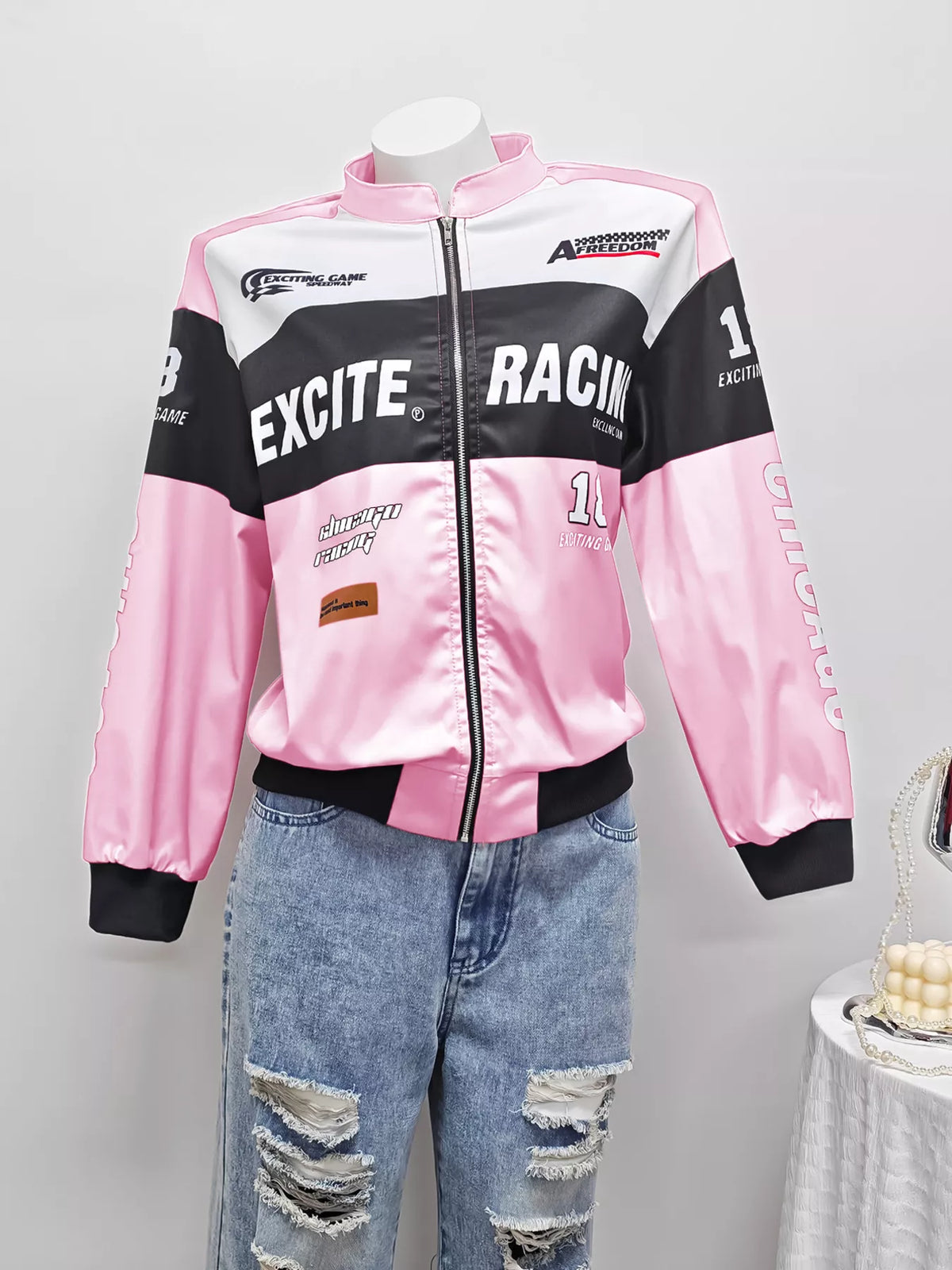 Pink and white letter-print zip-front jacket, front on mannequin