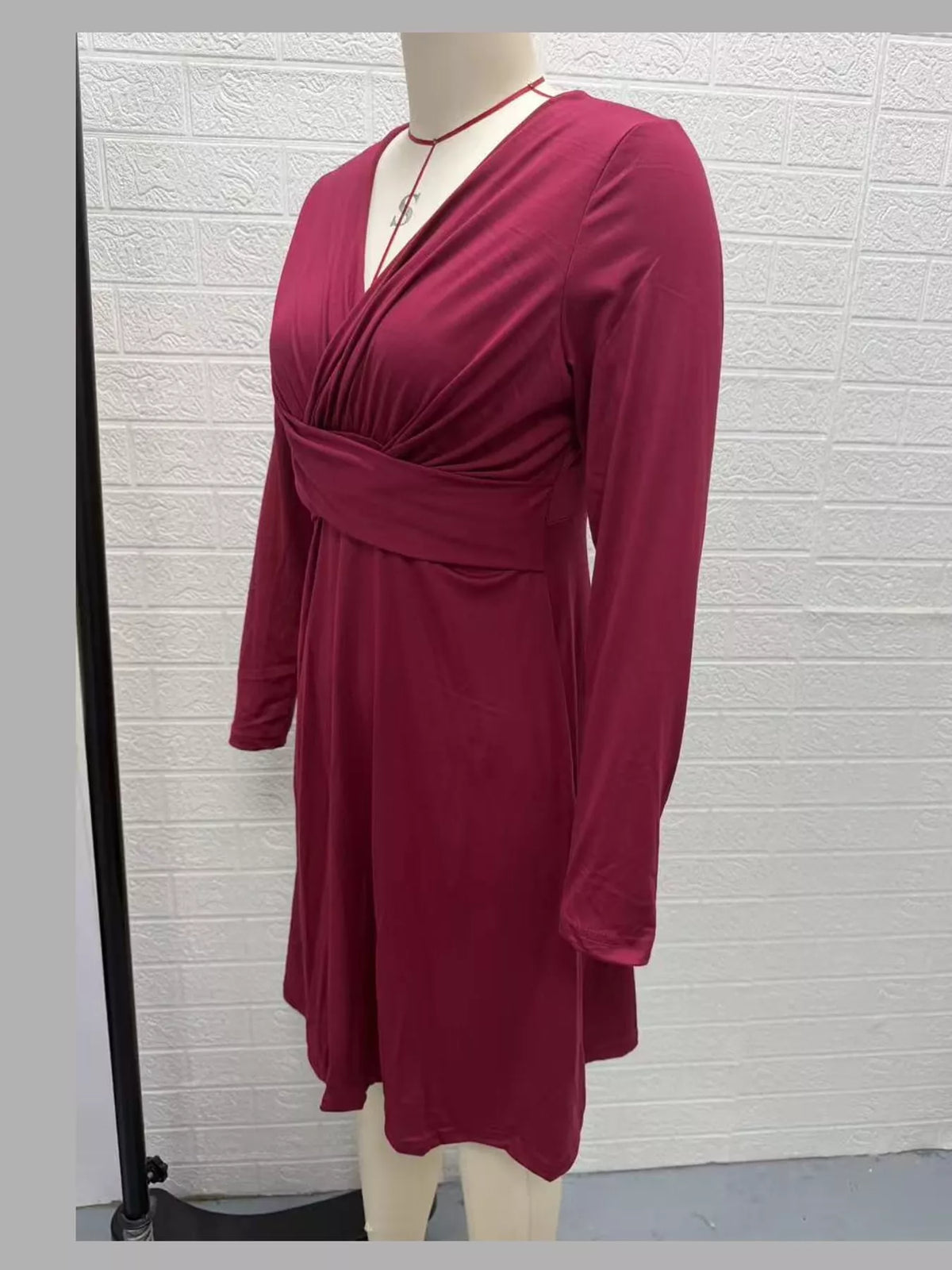 Burgundy long sleeve ruched-front midi dress, side view