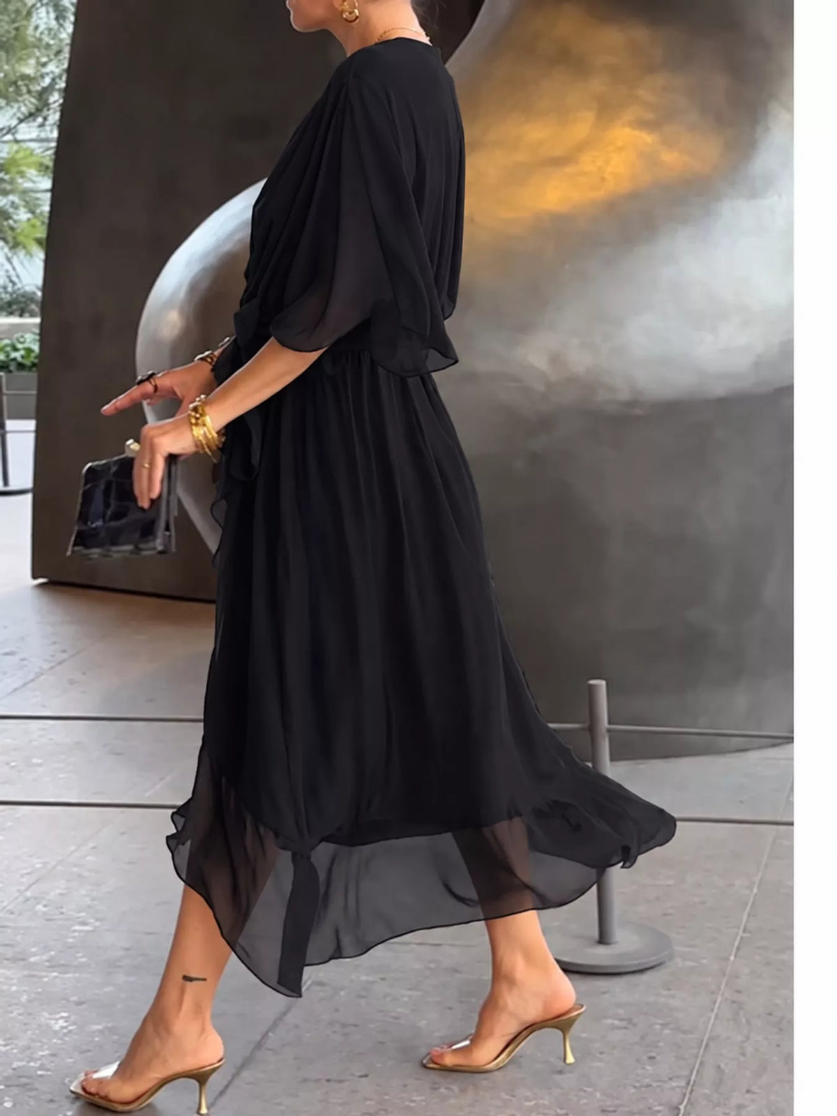 Black batwing sleeve wrap dress with waist tie, side view