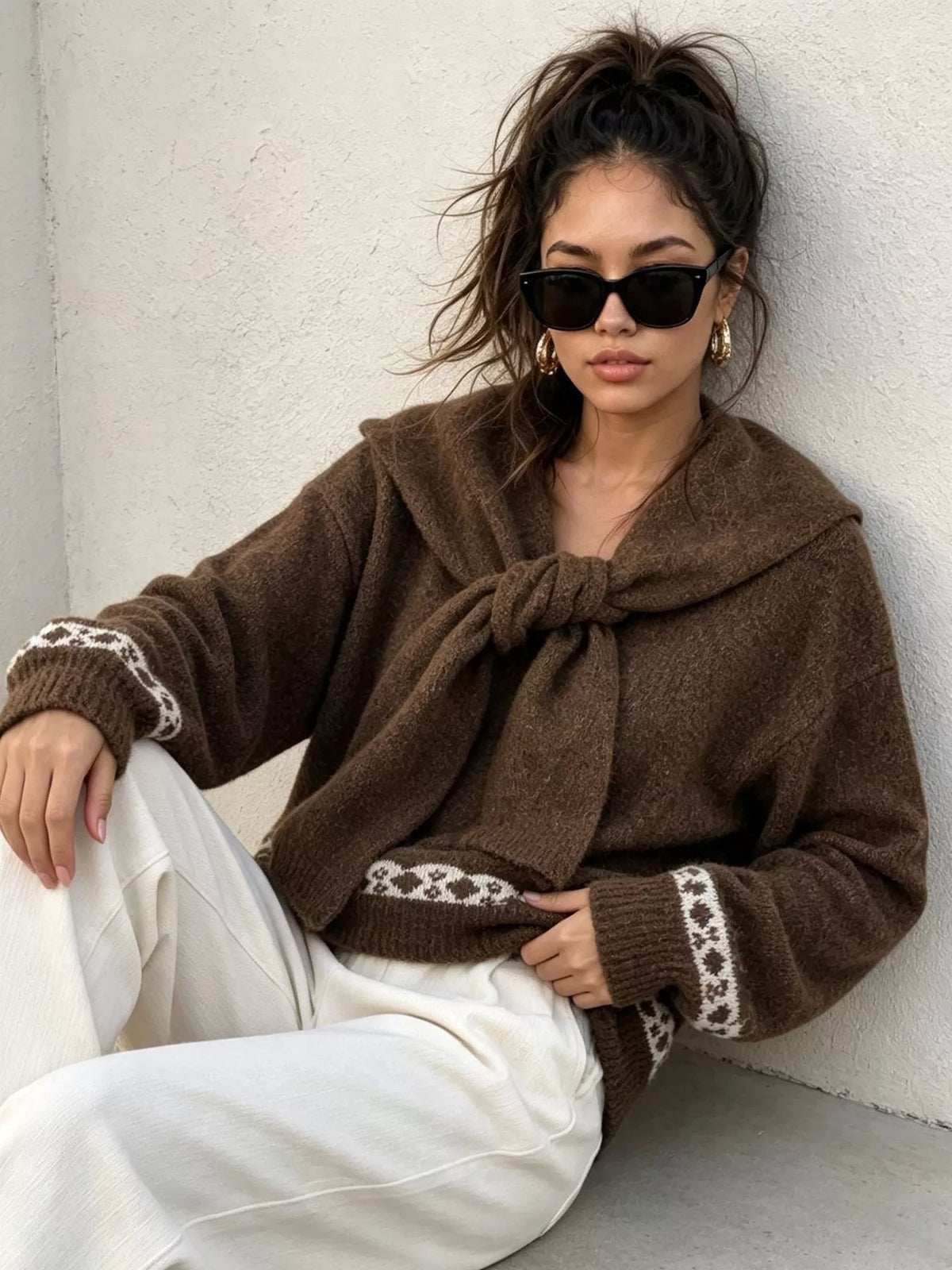 Brown scarf-detail dropped-shoulder sweater, seated front view.