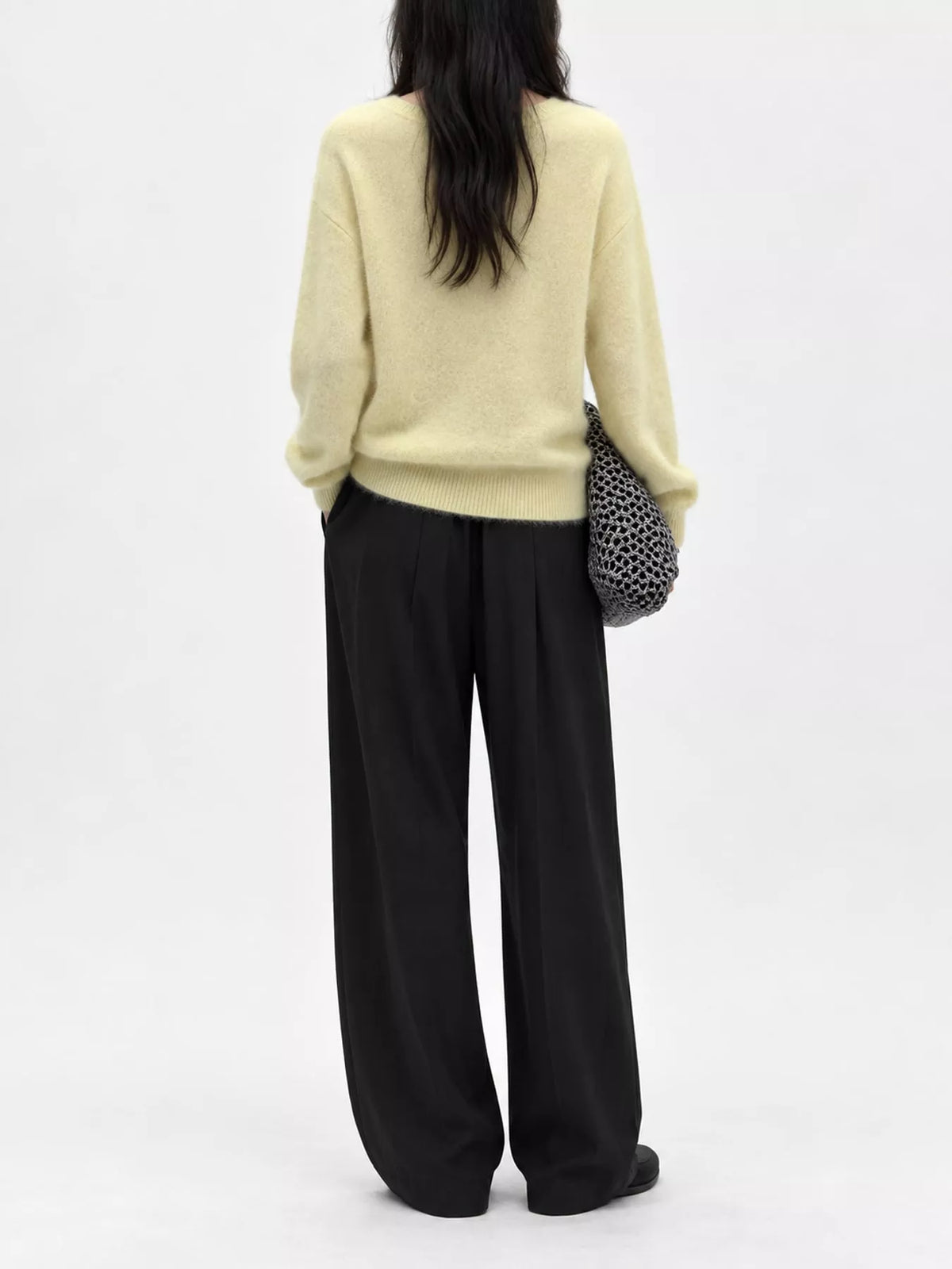 Yellow v-neck sweater, back view