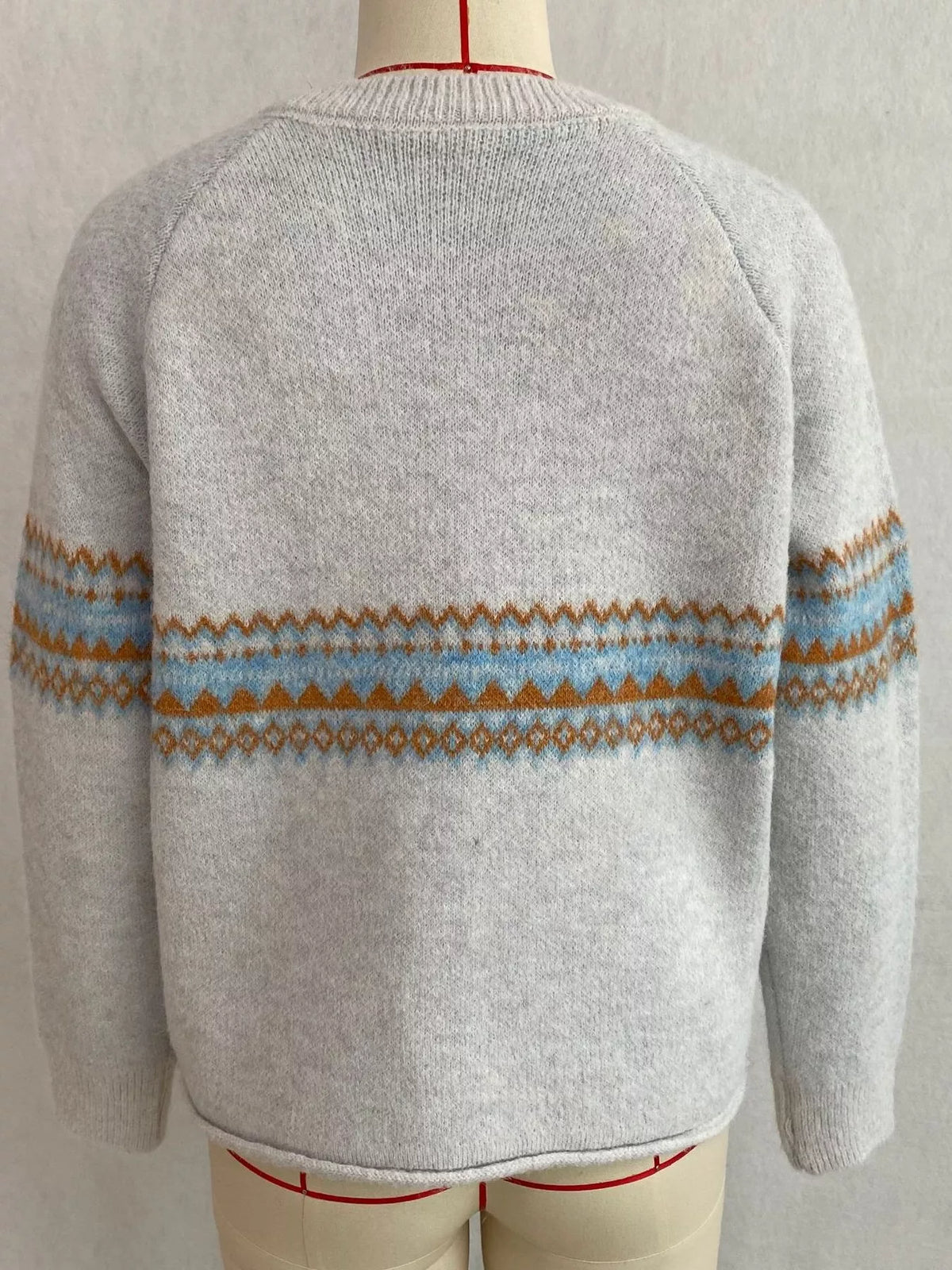 Light gray geometric button-front knit cardigan, back on dress form.
