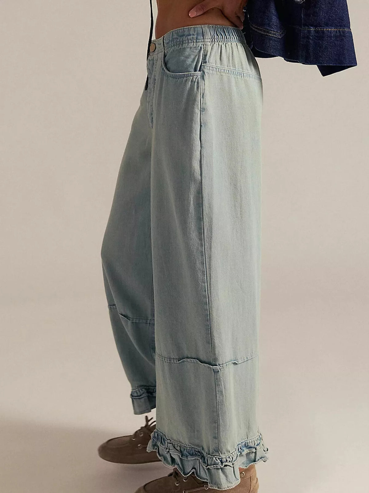 Light blue wide-leg ruffle-hem jeans, side view