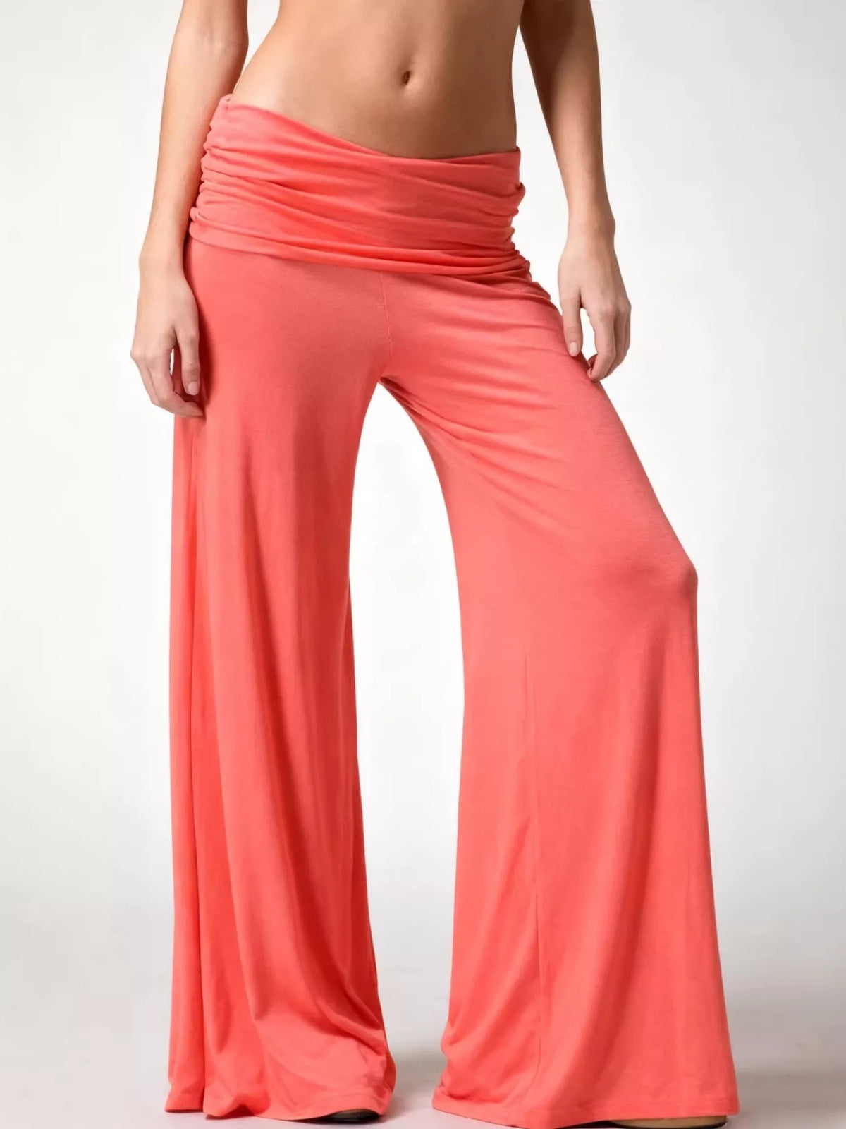 Coral fold-over wide-leg pants, front view with one knee bent