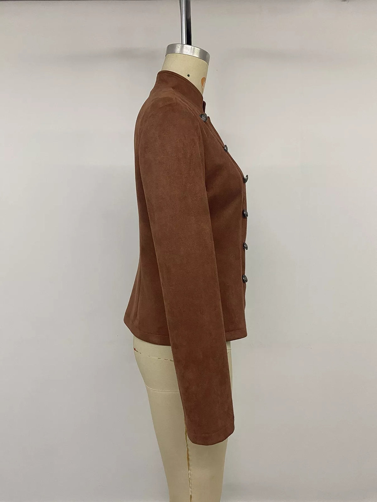 Brown stand collar cropped jacket with decorative buttons, side on mannequin