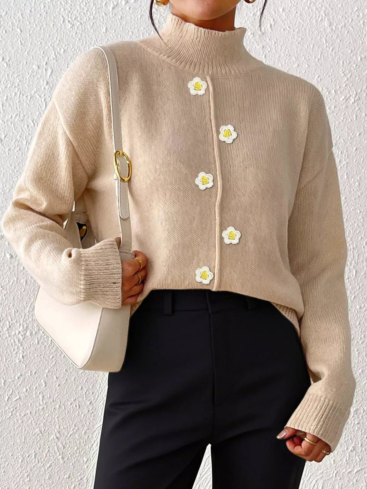 Beige floral applique mock-neck sweater, front partially tucked.