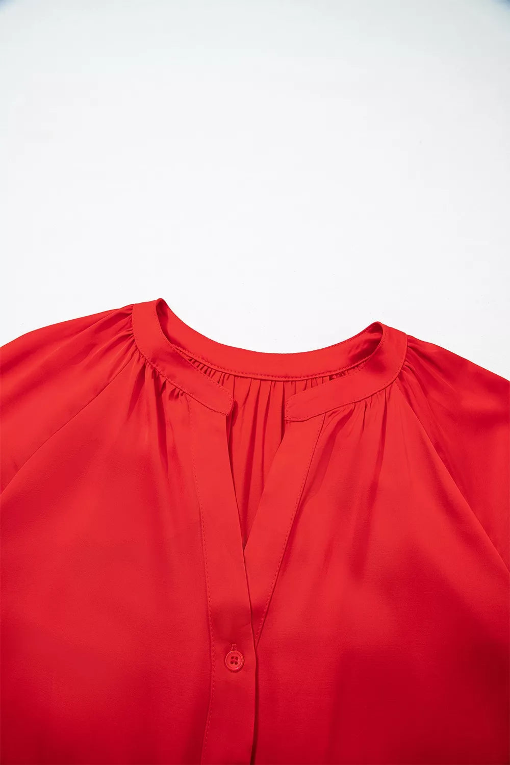 Red lace-panel v-neck button-front shirt, split neckline detail.