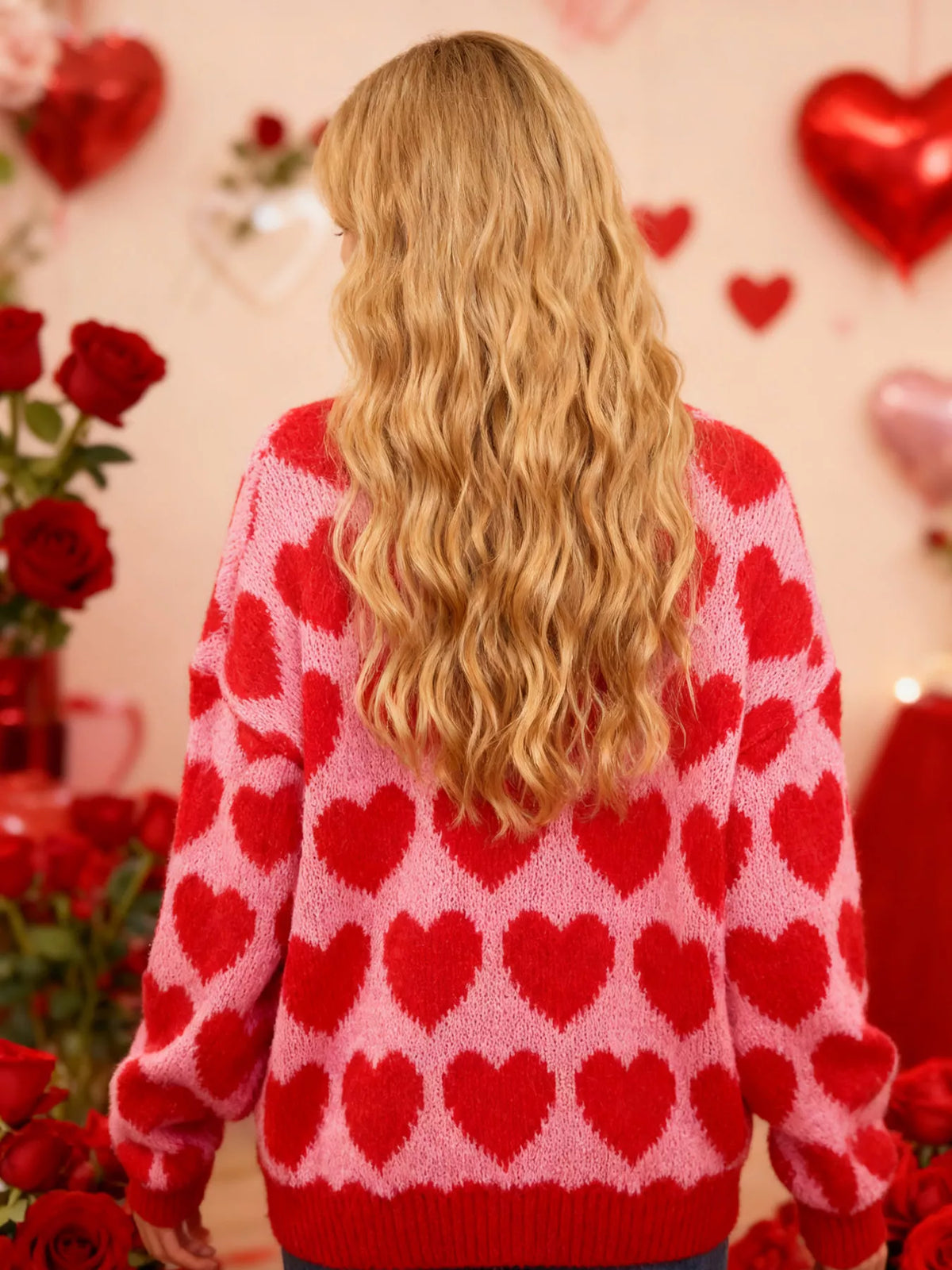 Pink and red allover heart dropped-shoulder sweater, back view.