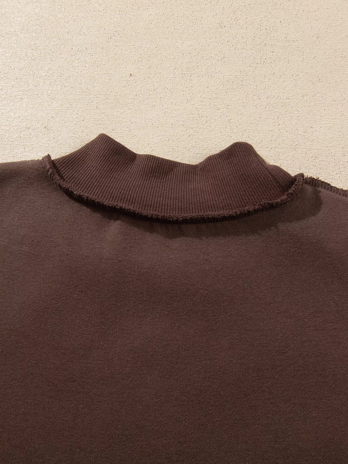 PRAY Polka Dot Embroidered Mock Neck Sweatshirt in dark brown, construction detail