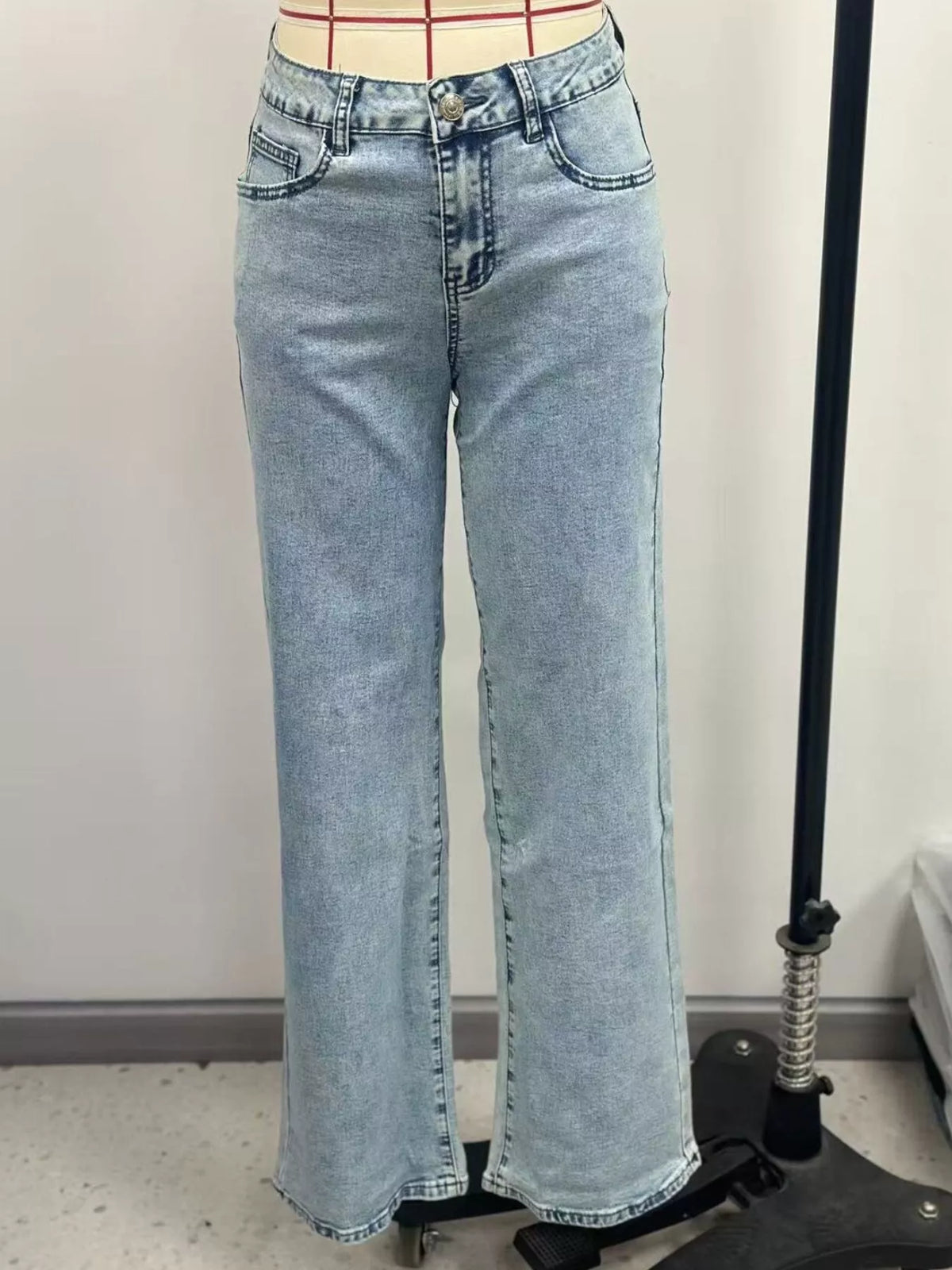 Light blue high-waisted acid-wash straight-leg jeans, front on dress form.