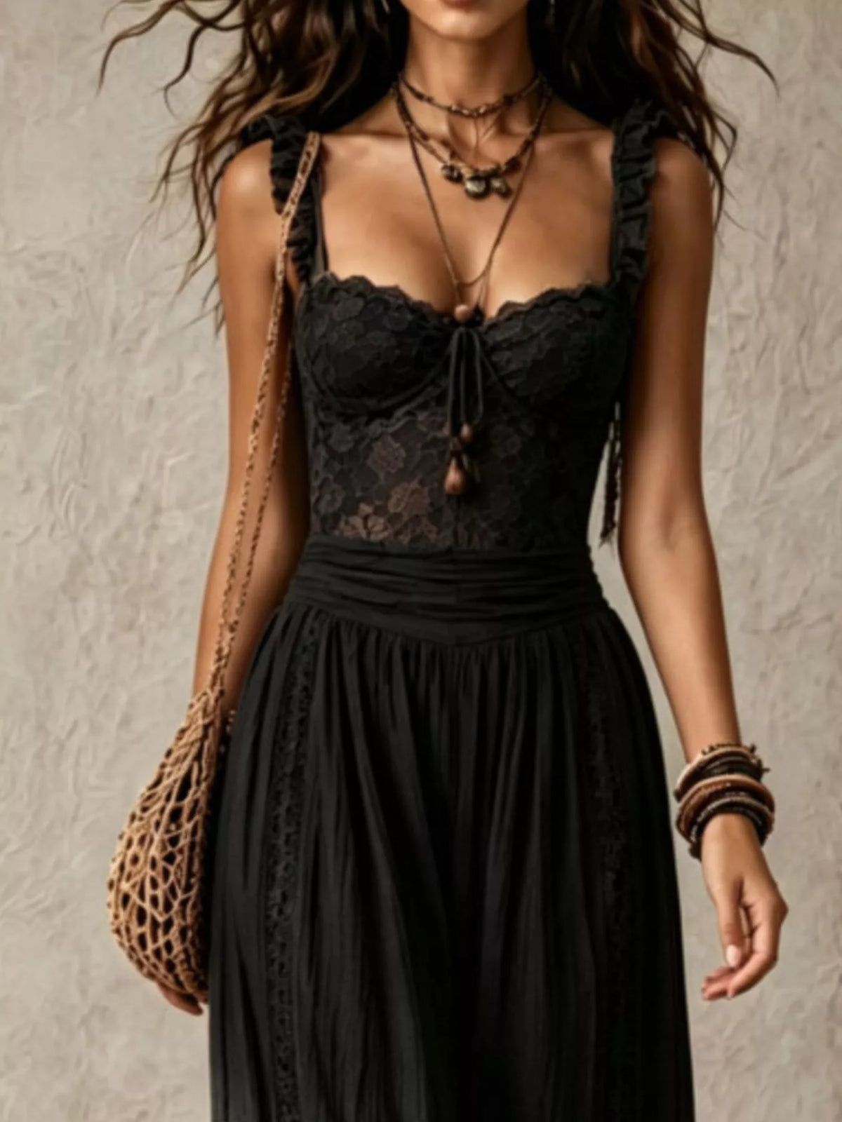Black lace-bodice harem-leg jumpsuit, lace bodice detail.
