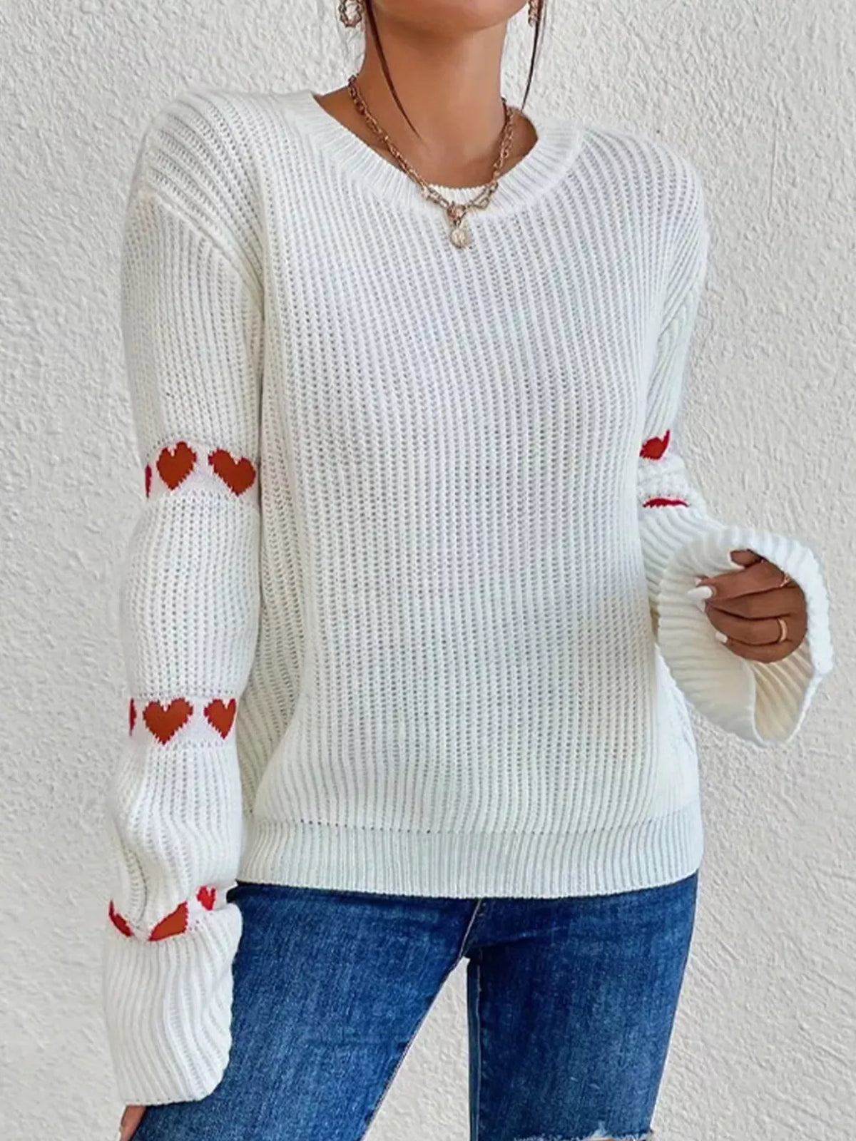 White and red heart-sleeve dropped-shoulder sweater, front showing sleeve hearts.