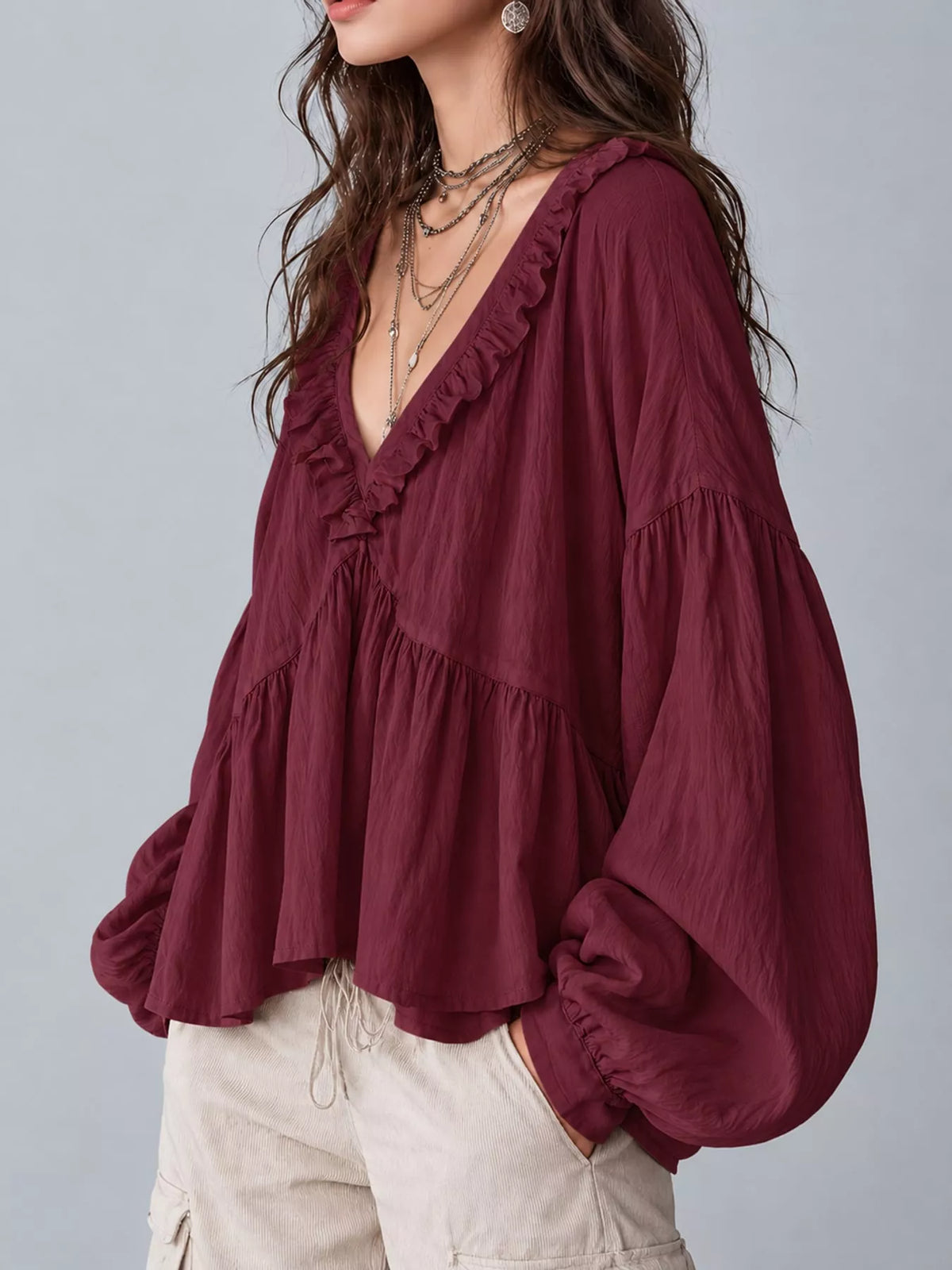 Burgundy ruffled v neck blouse, side view
