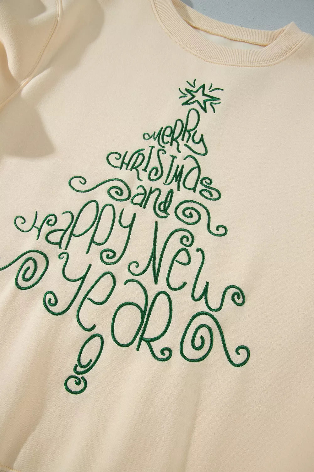 Merry Christmas and Happy New Year graphic on cream christmas tree merry christmas and happy new year sweatshirt
