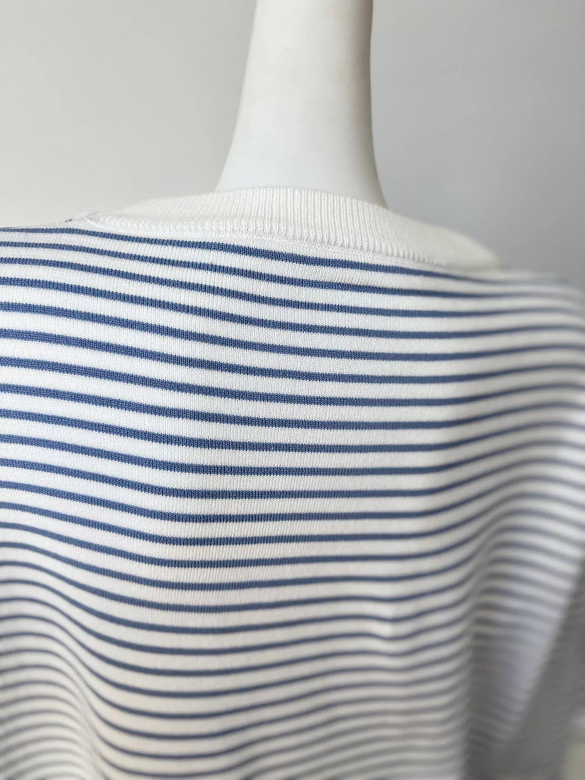 Striped round-neck knit top in white and blue, back neckline detail