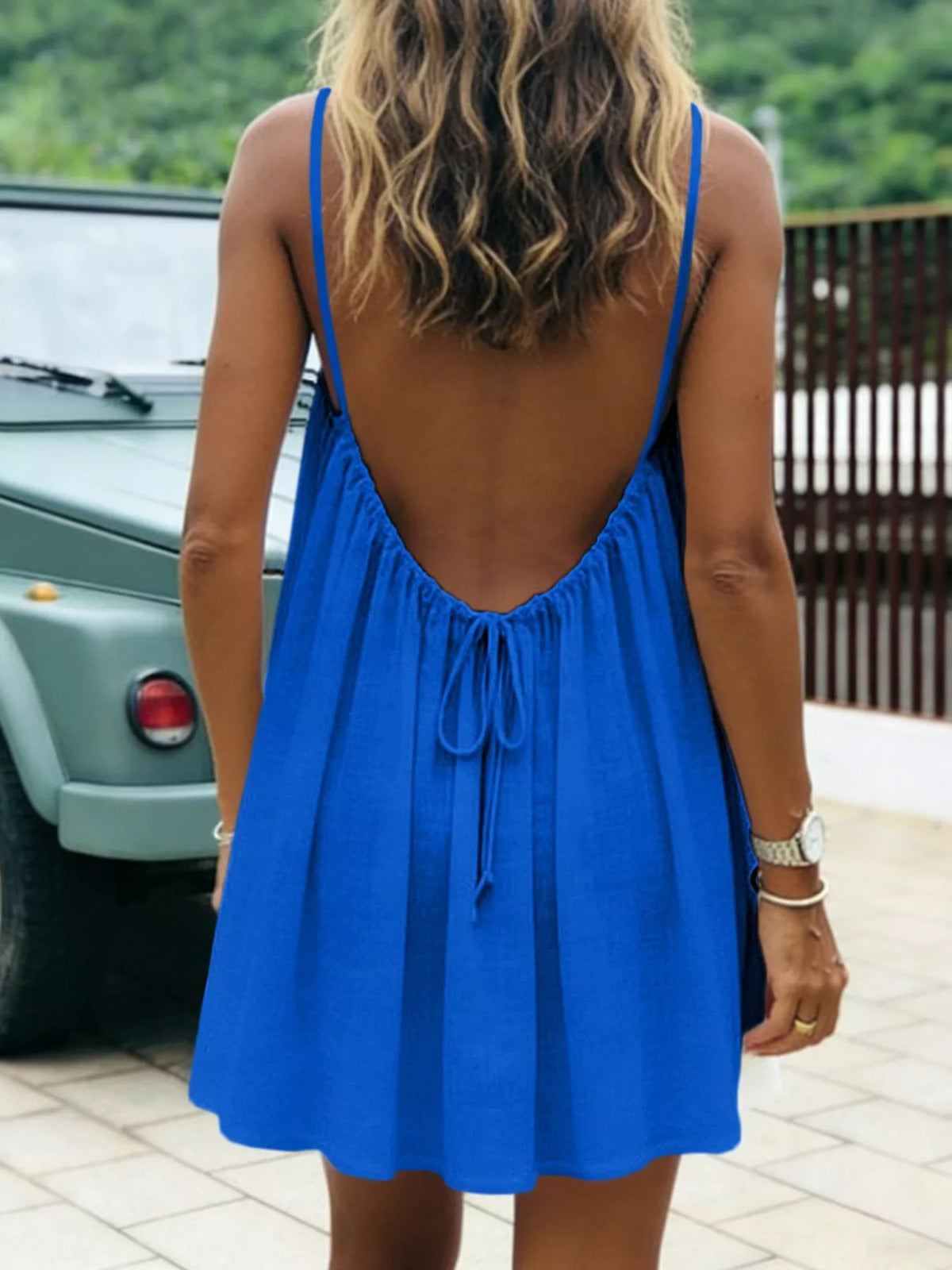 Blue spaghetti strap A-line mini dress with open tie back, open back view
