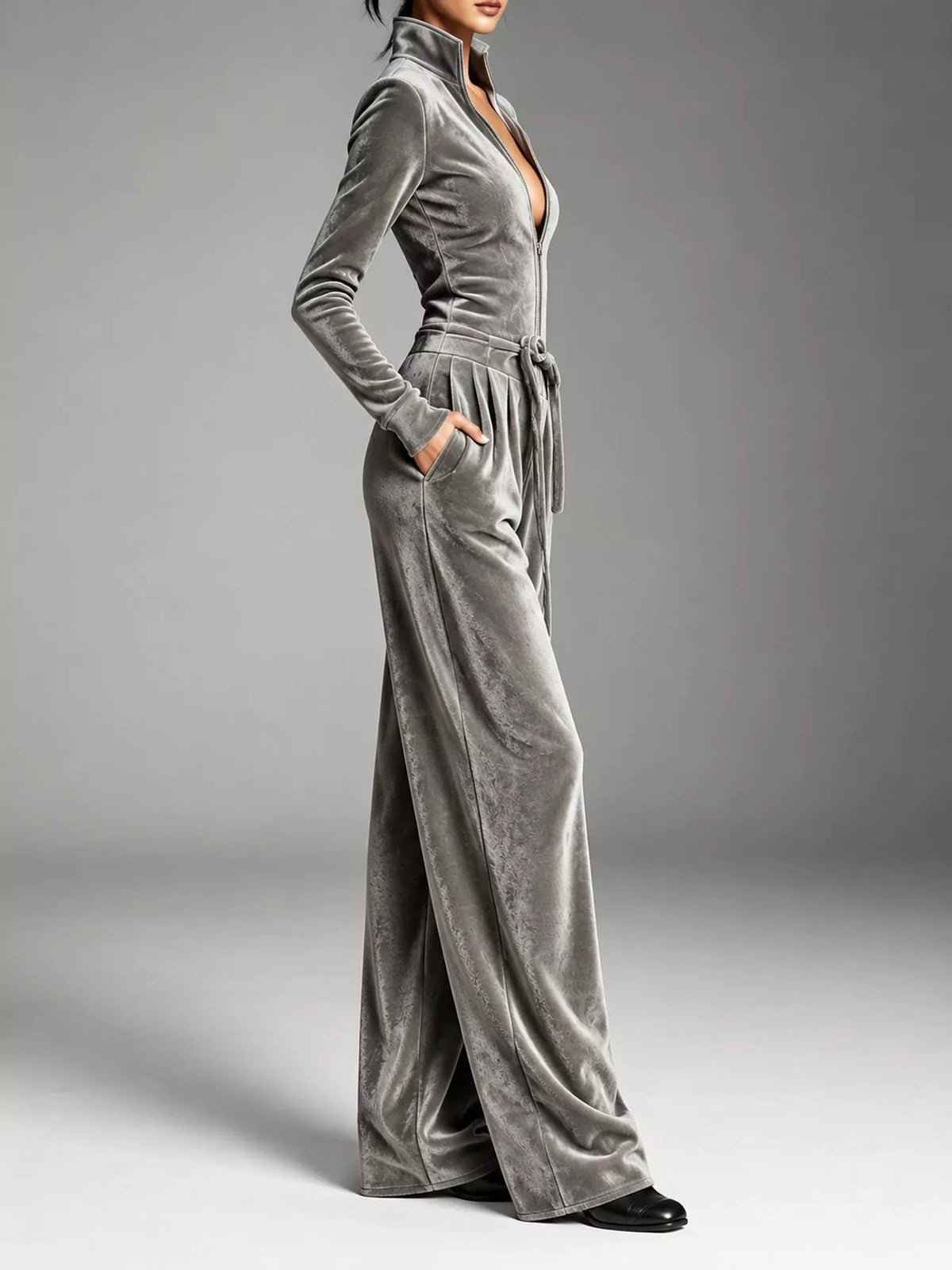 Gray velvet zip up jumpsuit with tie waist, side view