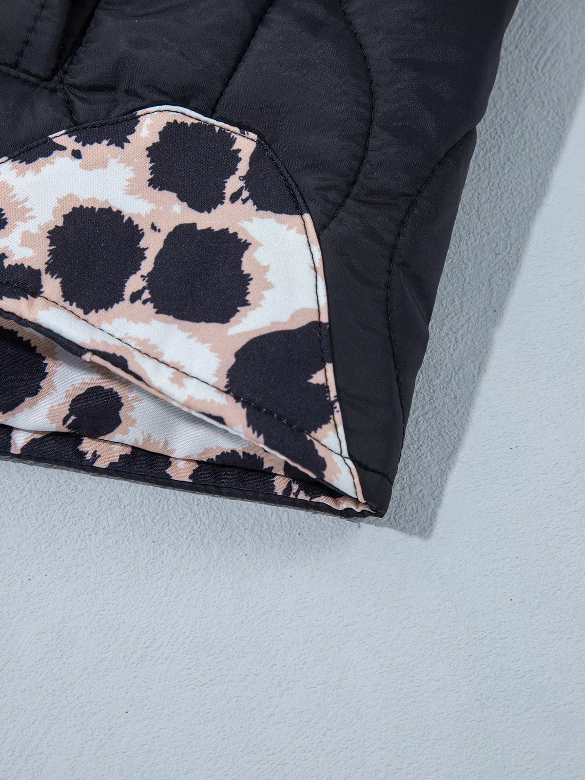 Quilted Leopard Cuff Button Down Puffer Jacket in black, construction detail